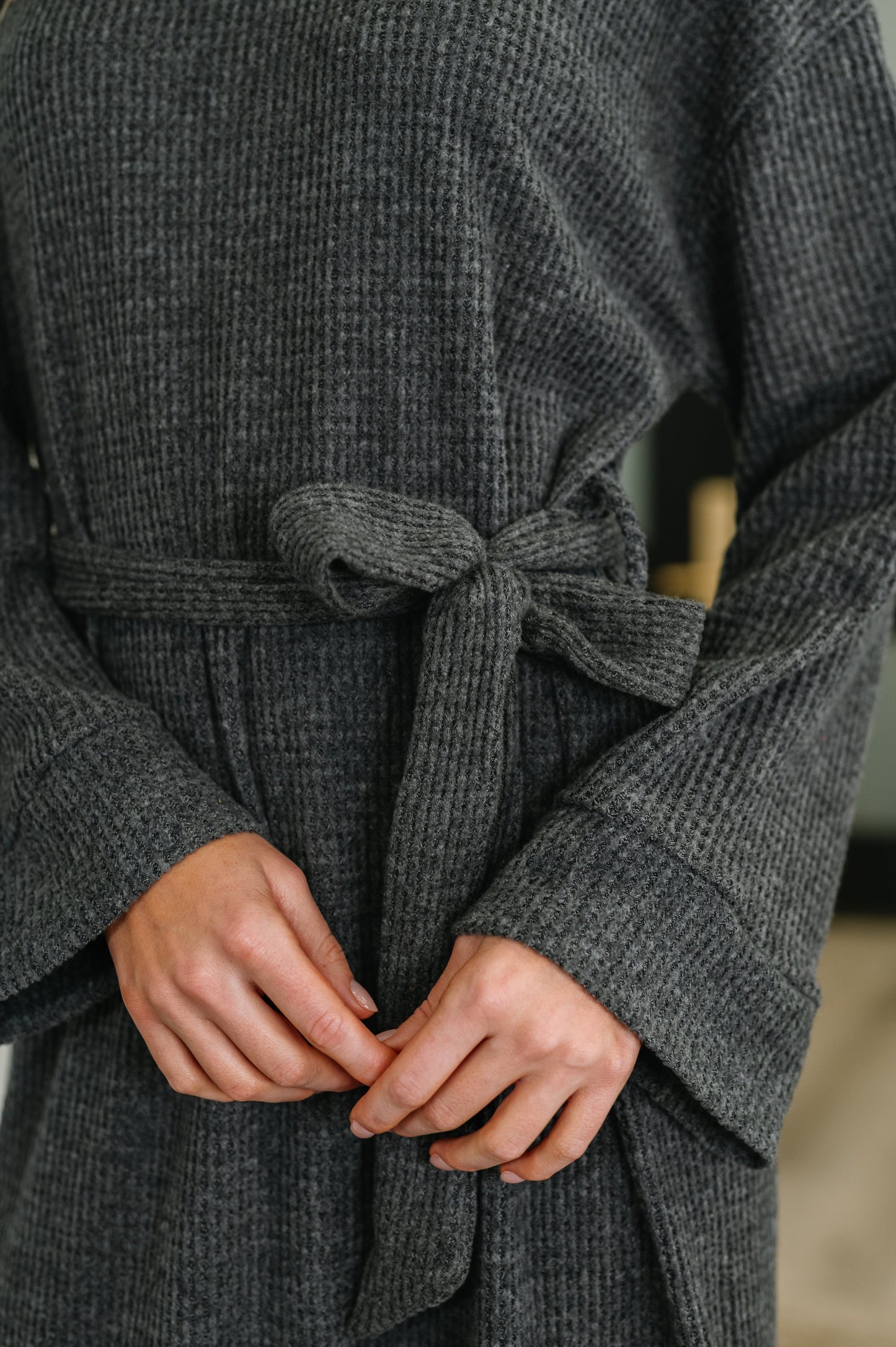 Close-up of Travita Plush Knit Dress turtleneck and textured waffle knit fabric.