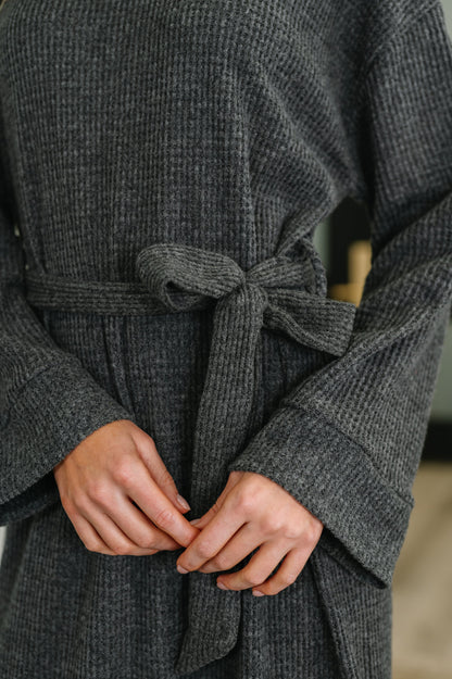 Close-up of Travita Plush Knit Dress turtleneck and textured waffle knit fabric.