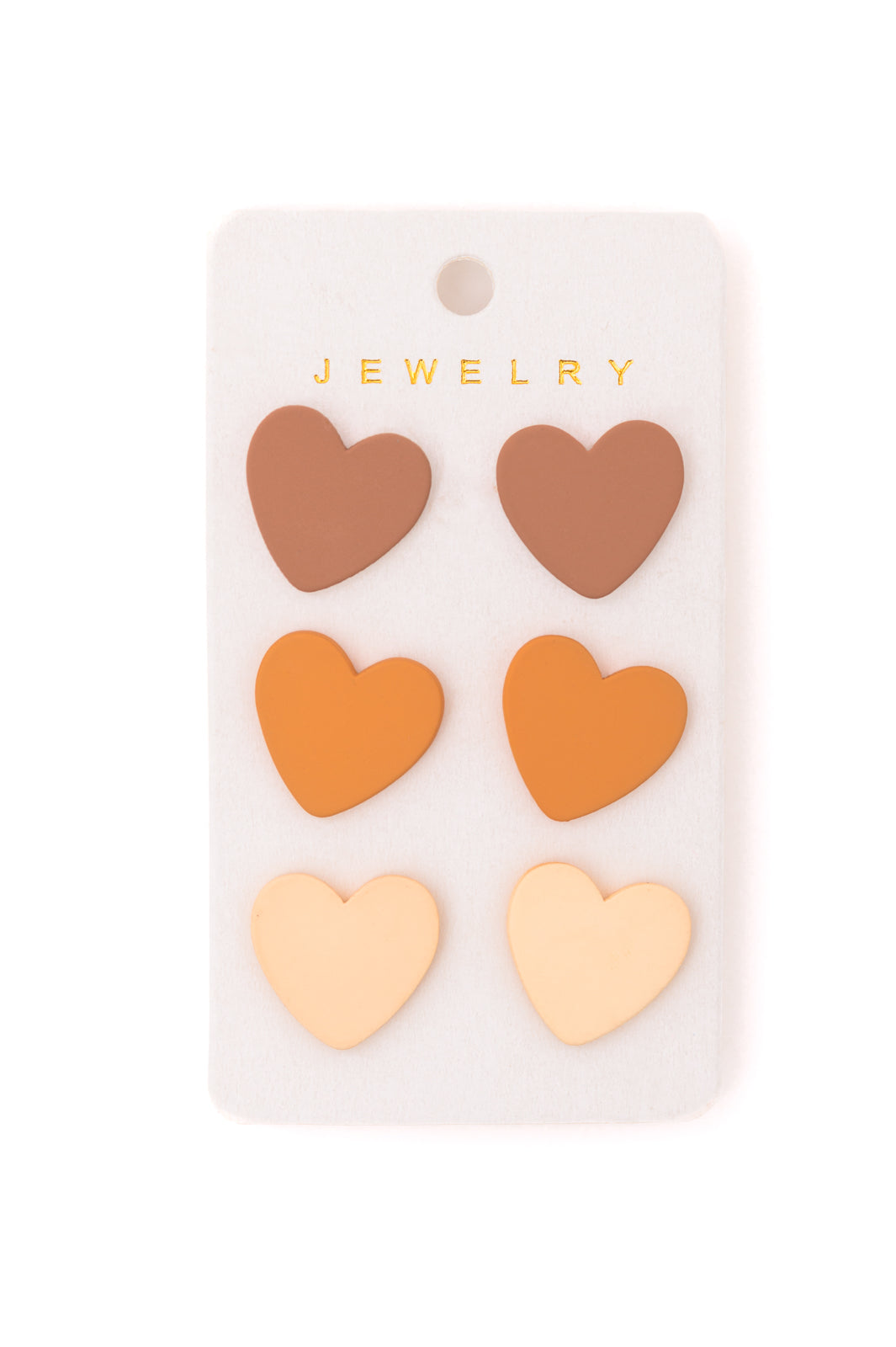 3 Pack of heart stud earrings in neutral colors.