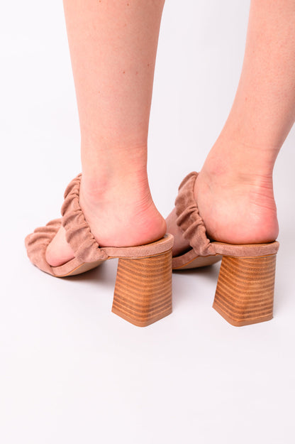 Woman wearing blush suede Palesa heels, back view showing scrunchy strap and heel height.