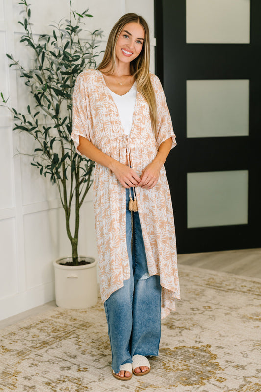 Model wearing Tropical Print Gauze Kimono with lightweight fabric and dolman sleeves.