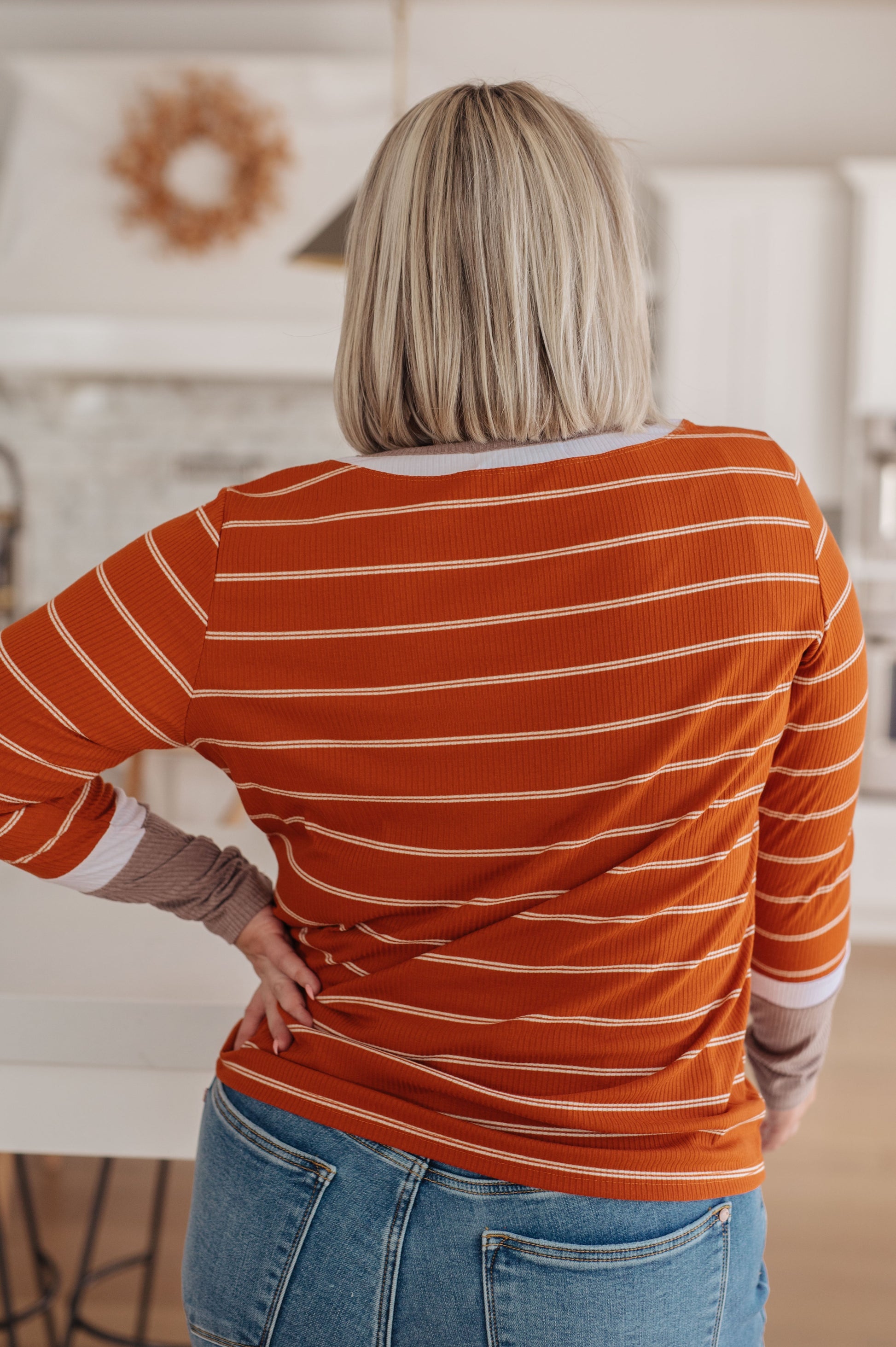 Orange and white striped ribbed jersey knit long sleeve tee with taupe color-blocked cuffs and a slim fit.