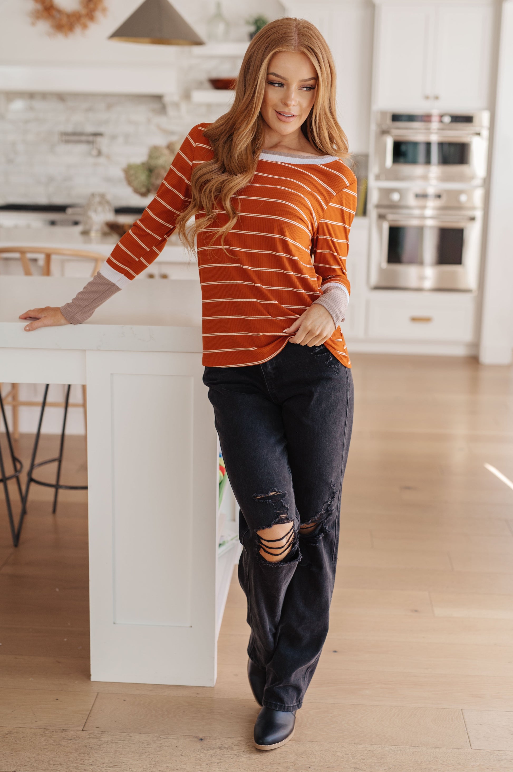 Orange and white striped ribbed jersey knit long sleeve tee with taupe color-blocked cuffs and a slim fit.