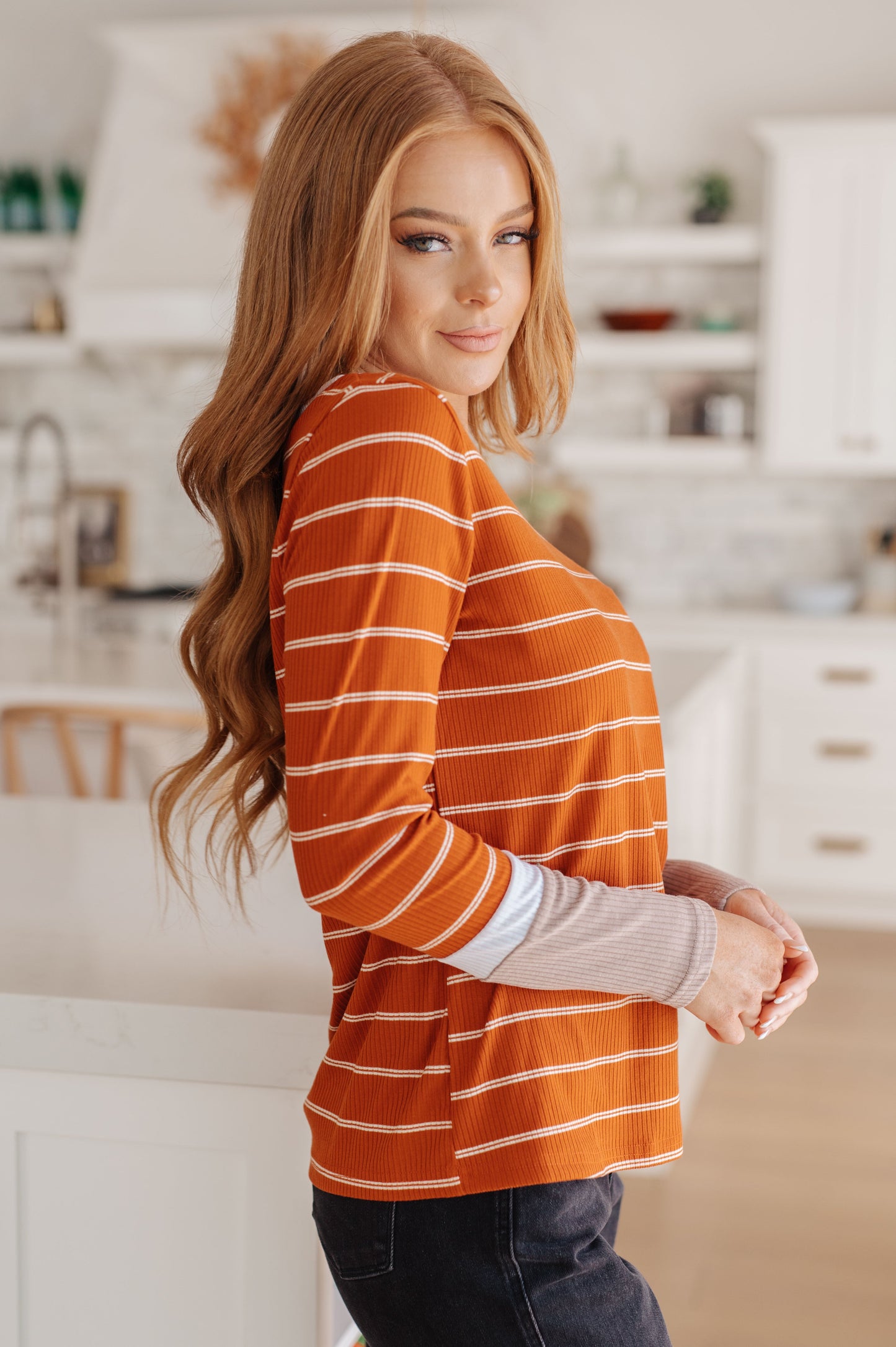 Orange and white striped ribbed jersey knit long sleeve tee with taupe color-blocked cuffs and a slim fit.