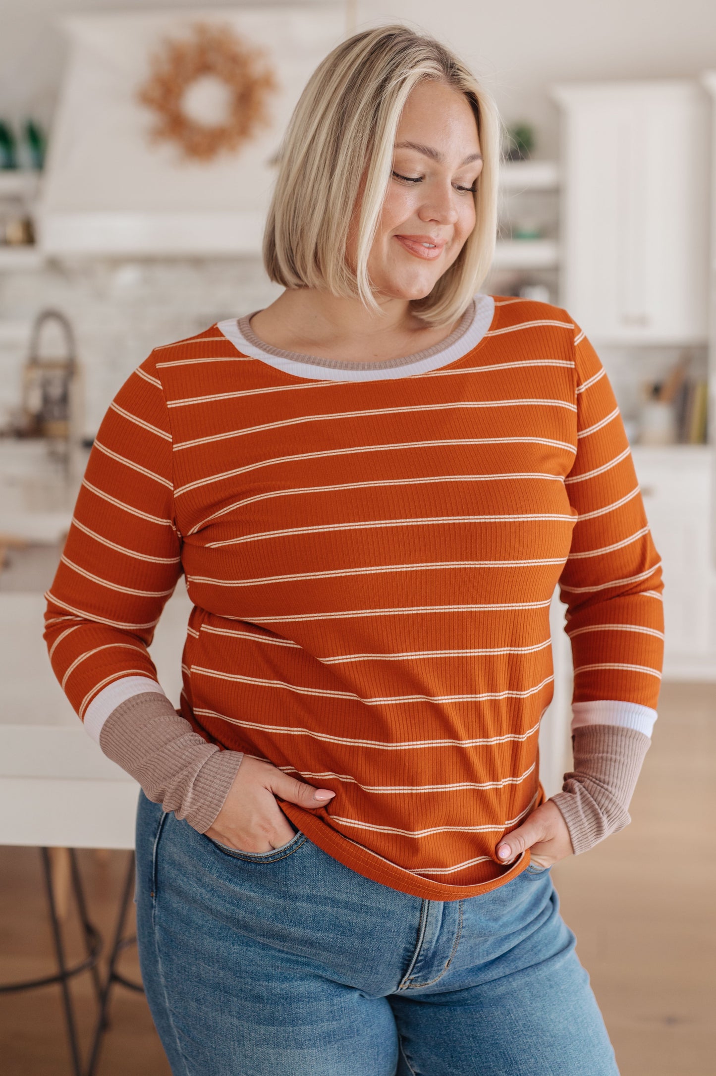 Orange and white striped ribbed jersey knit long sleeve tee with taupe color-blocked cuffs and a slim fit.