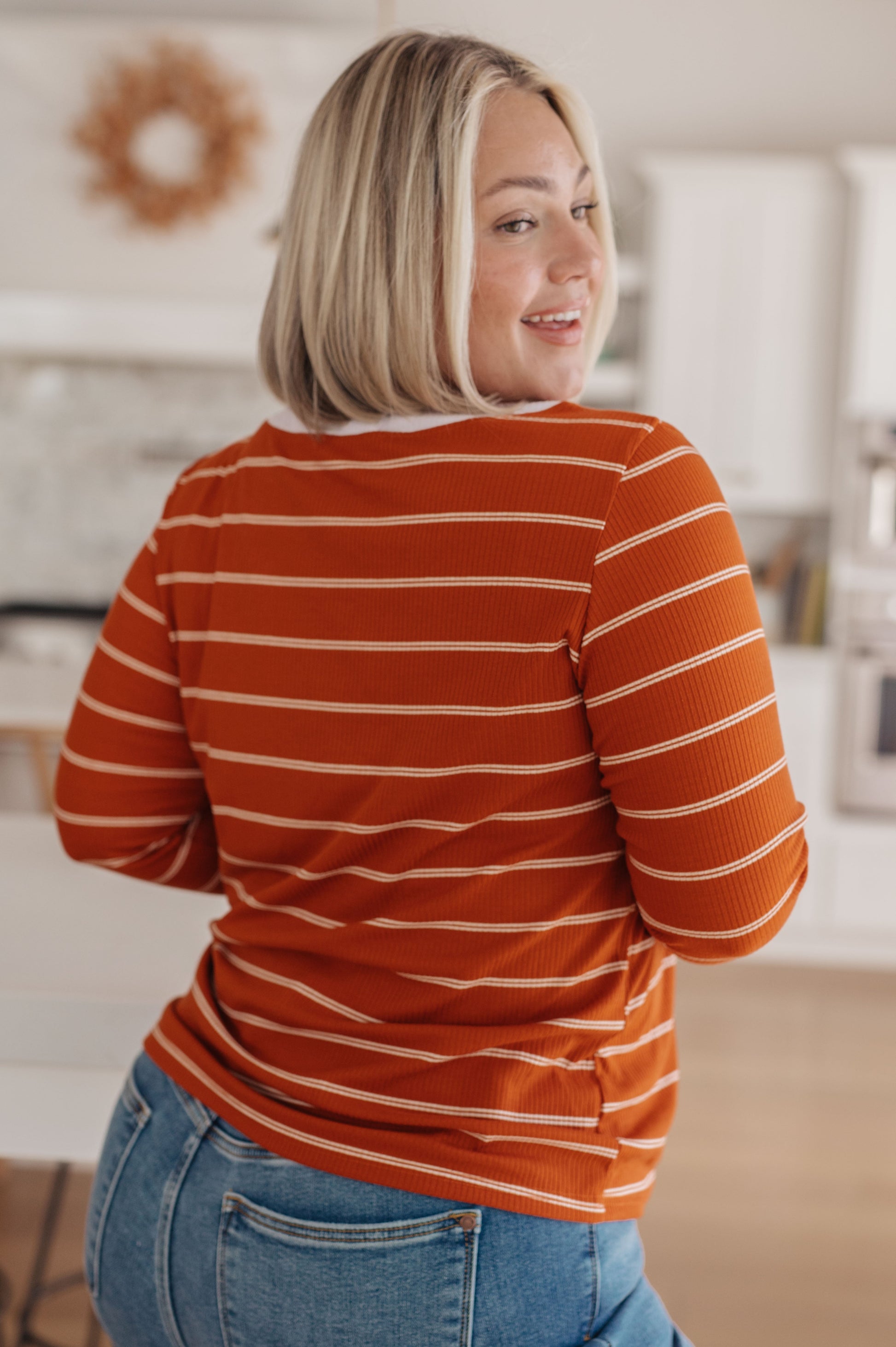 Orange and white striped ribbed jersey knit long sleeve tee with taupe color-blocked cuffs and a slim fit.