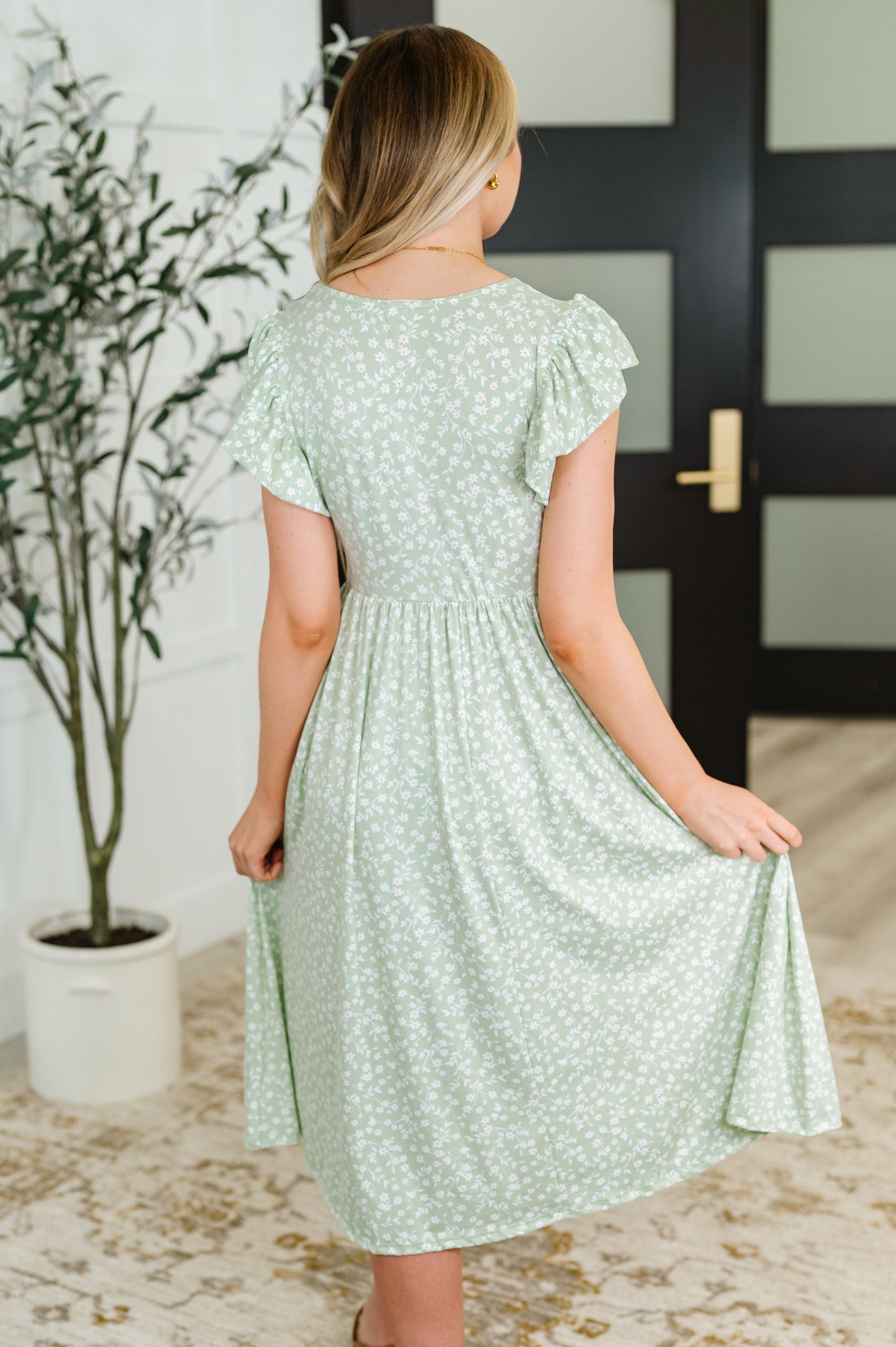 Back view of the Lakelynn Flutter Sleeve Dress in sage, showcasing the double-layered flutter sleeves and relaxed fit of the brushed knit fabric.