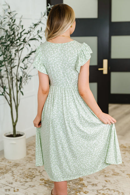 Back view of the Lakelynn Flutter Sleeve Dress in sage, showcasing the double-layered flutter sleeves and relaxed fit of the brushed knit fabric.