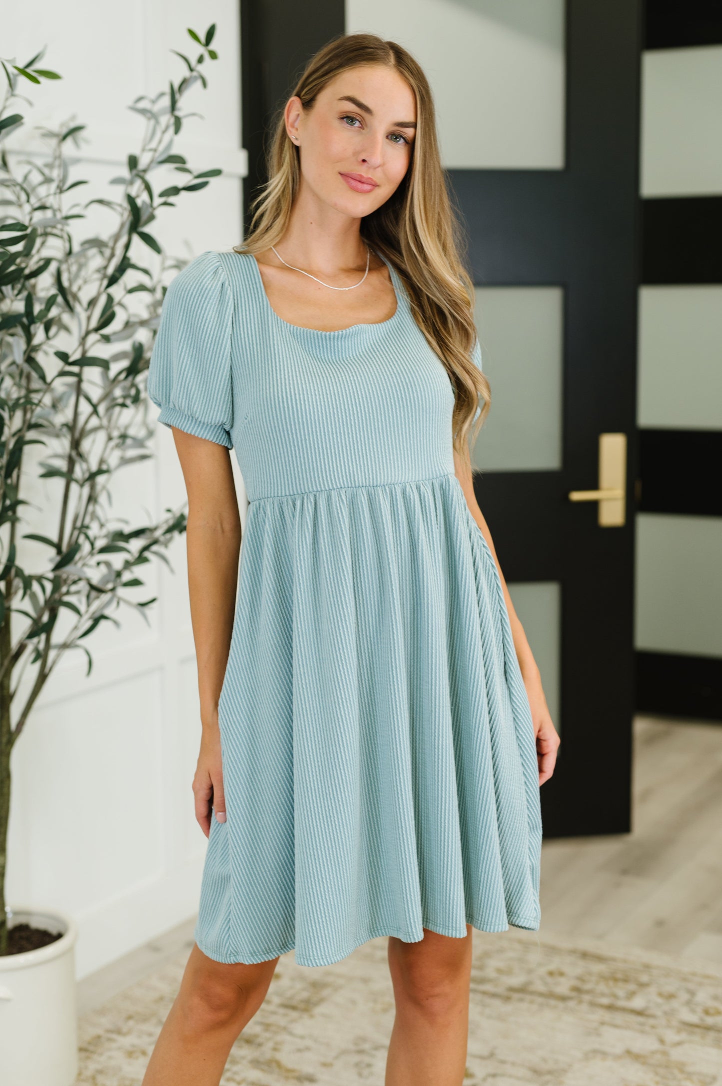 Front view of Genevieve sage green knit dress with balloon sleeves, square neckline, and gathered waist.