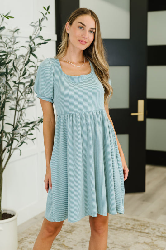 Front view of Genevieve sage green knit dress with balloon sleeves, square neckline, and gathered waist.