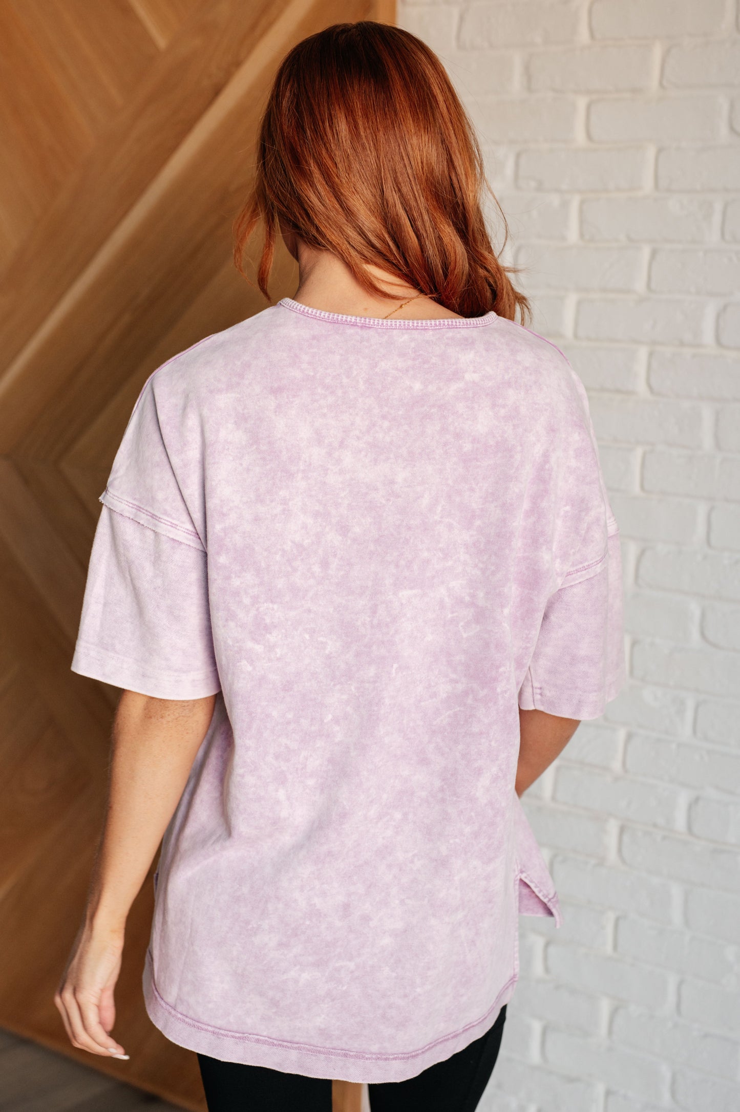 Women's Ubon Mineral Wash Top in Orchid Petal featuring a round neck, short sleeves with drop shoulders, raw edge details, stepped hem, and side slits. Made with French terry and waffle knit contrast fabric for a laid-back, effortless look.