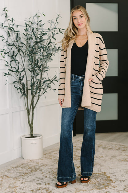 Full body view of model wearing Keziah Striped Cardigan with jeans and black top.
