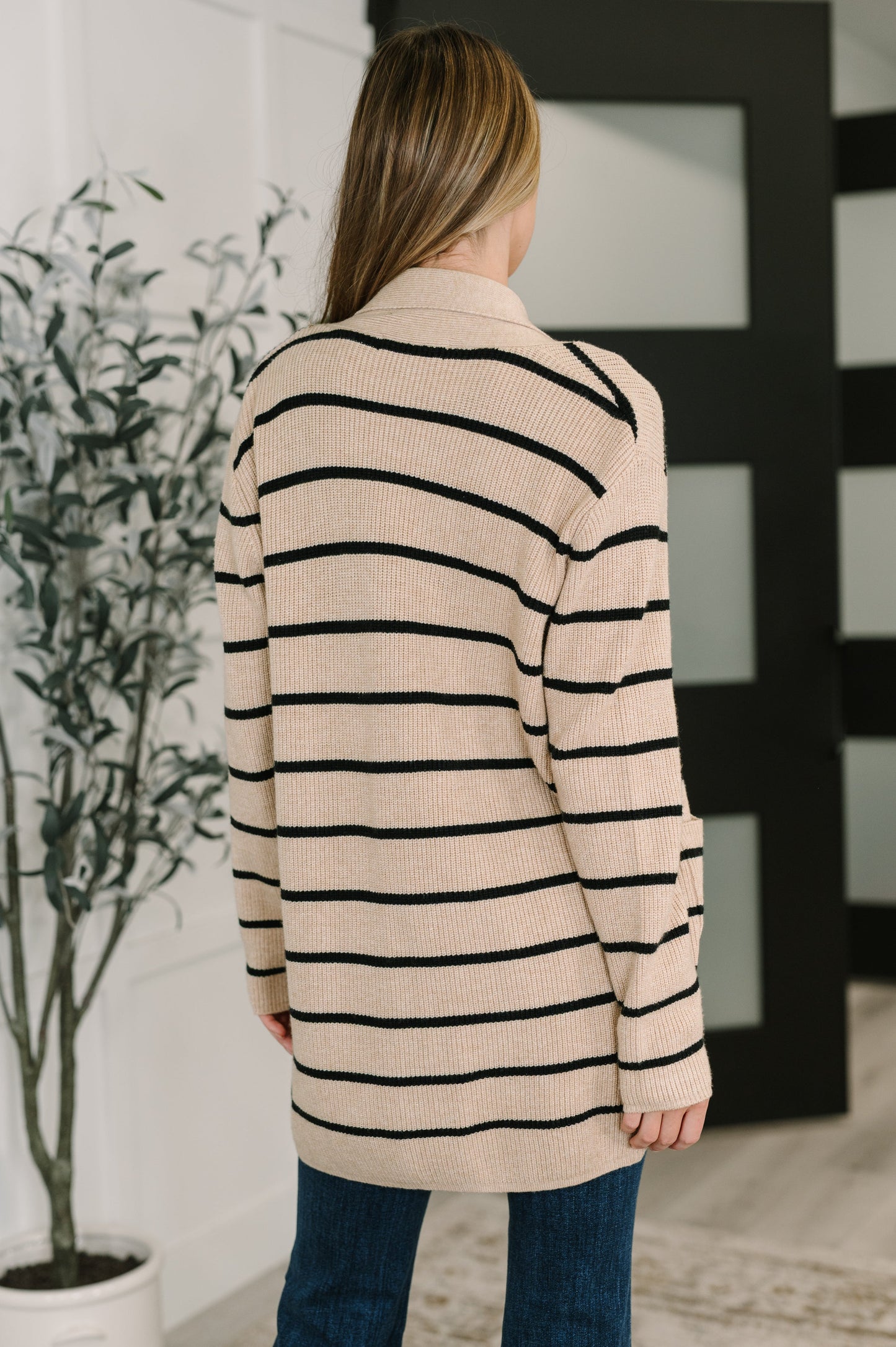 Back view of Keziah Striped Cardigan showing taupe color with horizontal black stripes.