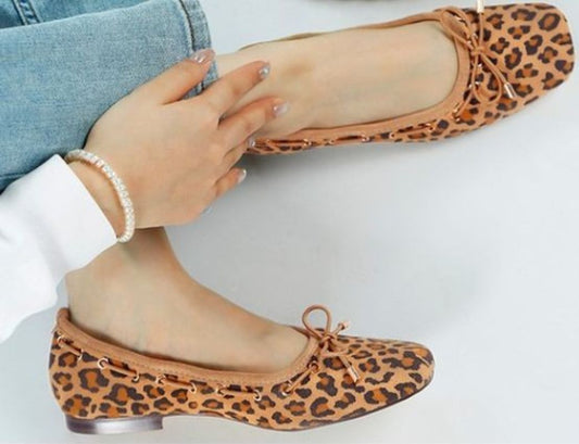 Model wearing Darlow Drawstring Bow Ballerinas in leopard suede