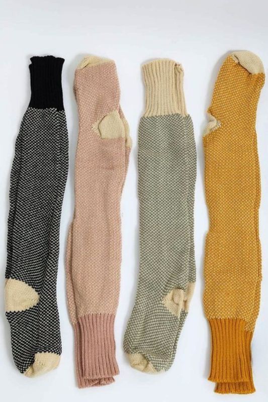 Flat lay of Jerica Knitted Lounge Socks in black, pink, mustard, and oatmeal colors.