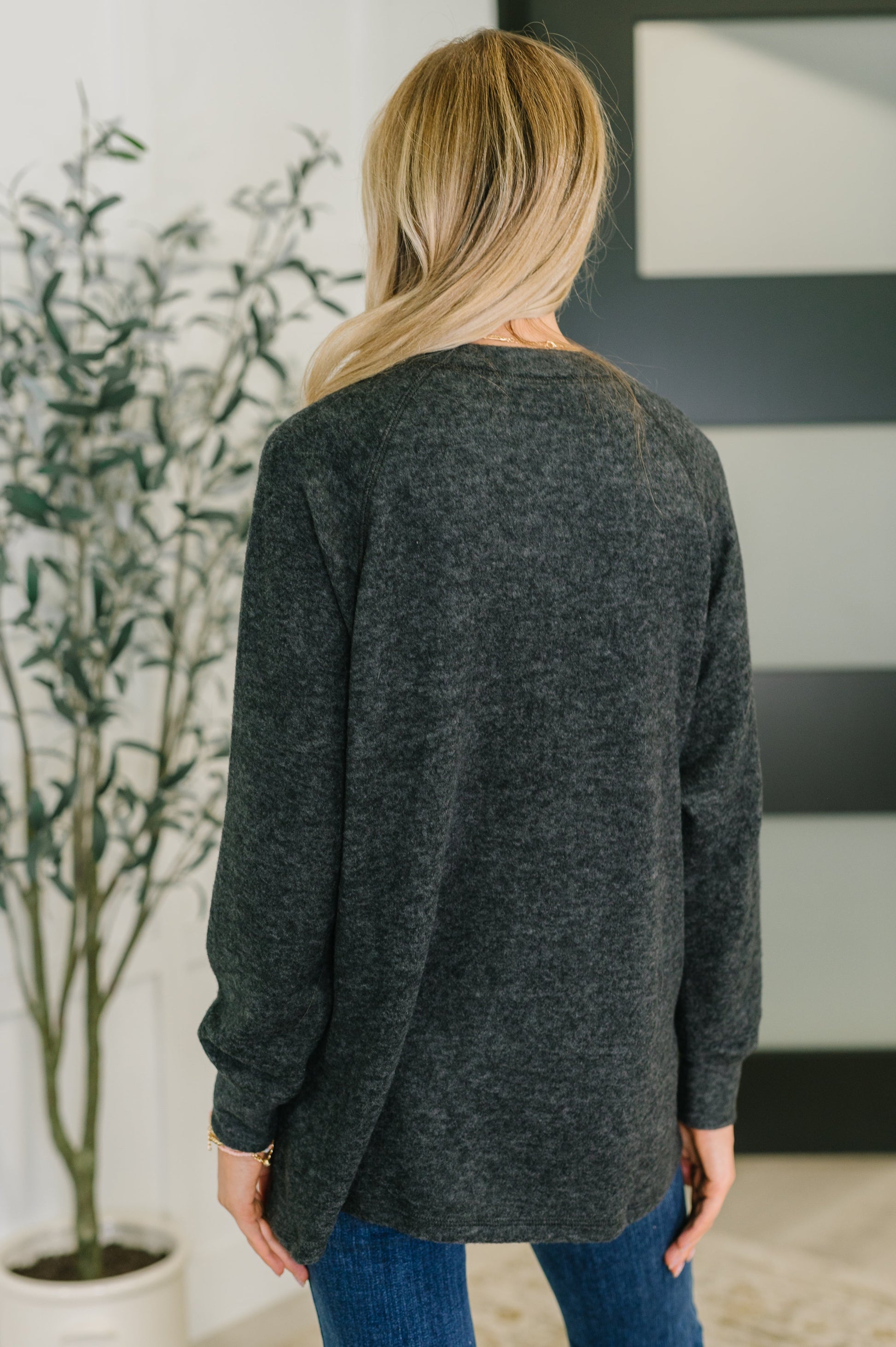 Murphy Black Pullover showing long sleeves and curved hemline.