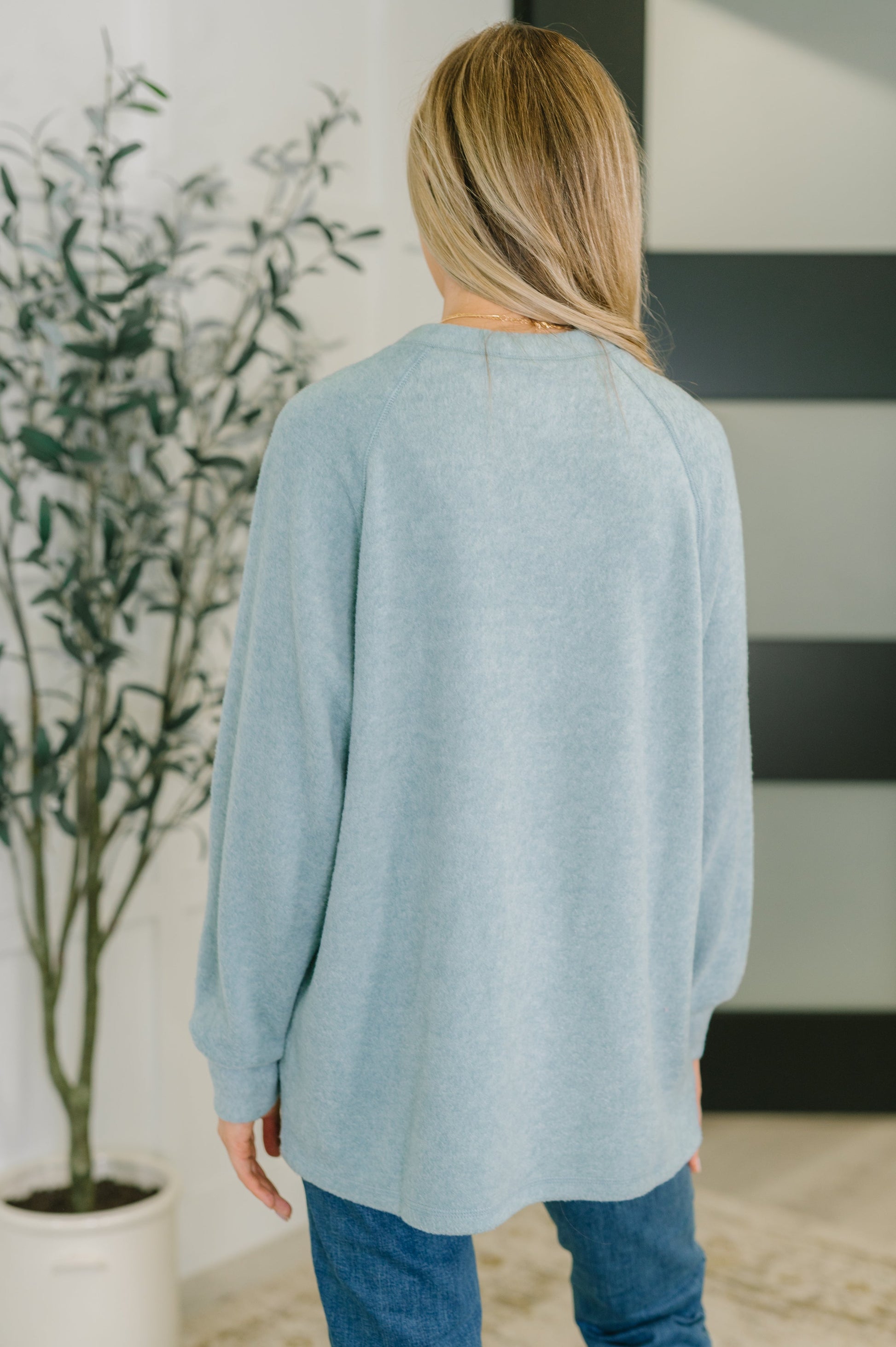 Murphy Blue Grey Pullover showing long sleeves and stepped hem.
