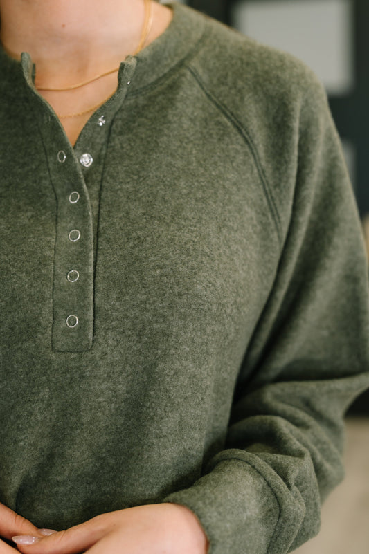 Murphy Olive Pullover close-up showing snap button neckline detail