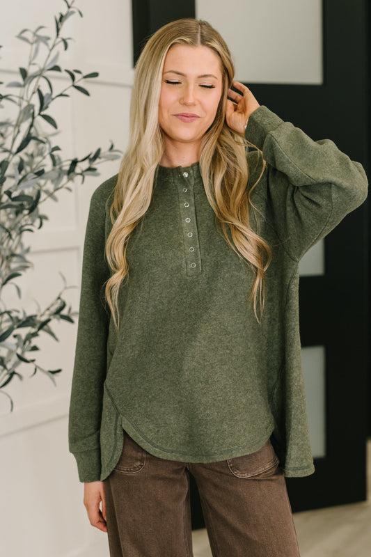 Murphy Olive Pullover front view, soft knit with hi-low hem and snap buttons