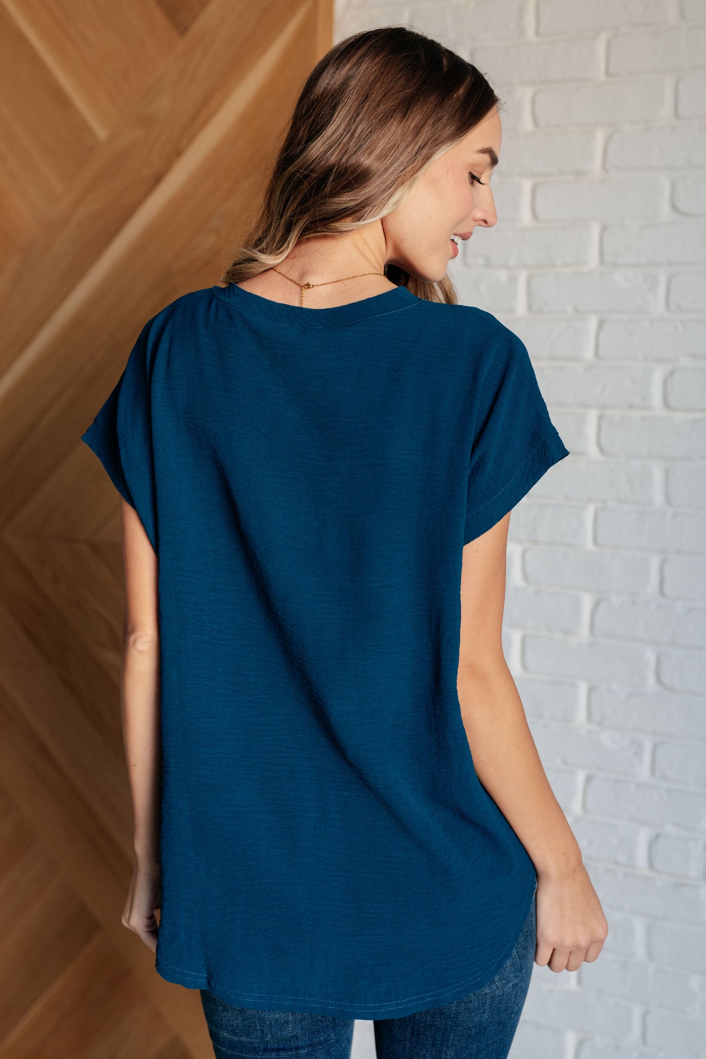 Women's V-Neck Top in Deep Teal, crafted from crinkle woven fabric with a flattering v-neckline and flowy fit.