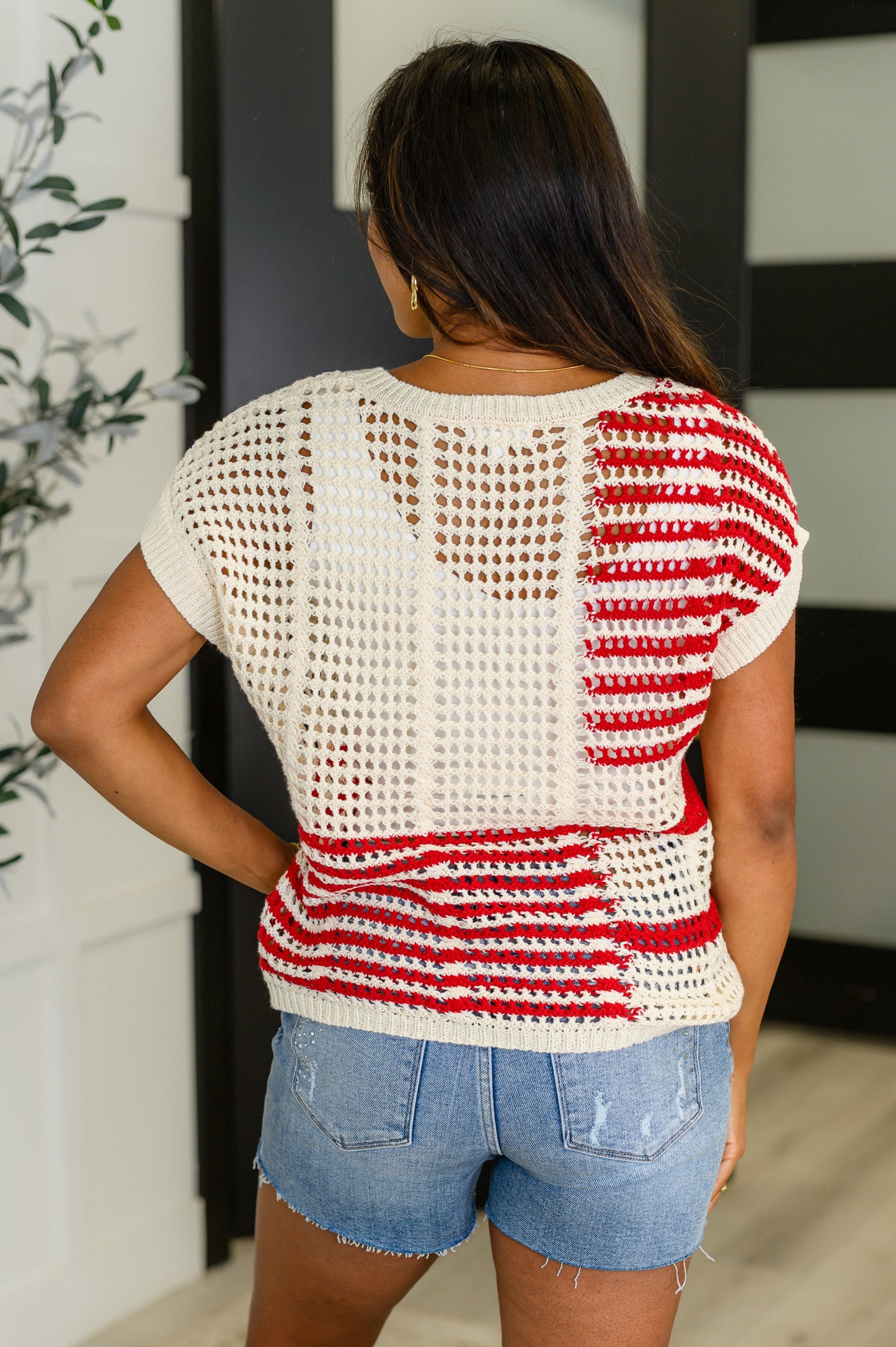 Back view of the Cora Net Tee, bold striped knit top with ribbed hemline and stretch.