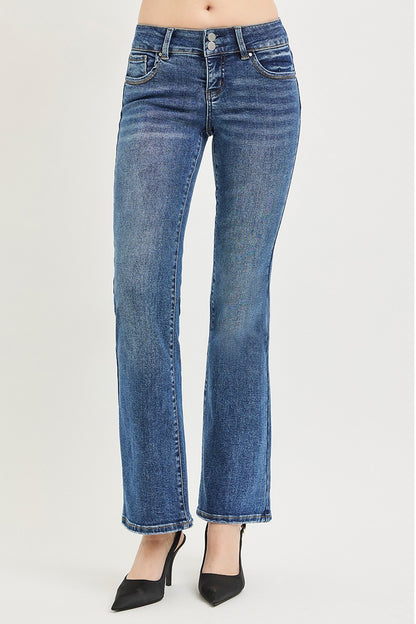 Model wearing Vinny Bootcut Jeans by Risen medium wash low rise with tummy control panel.