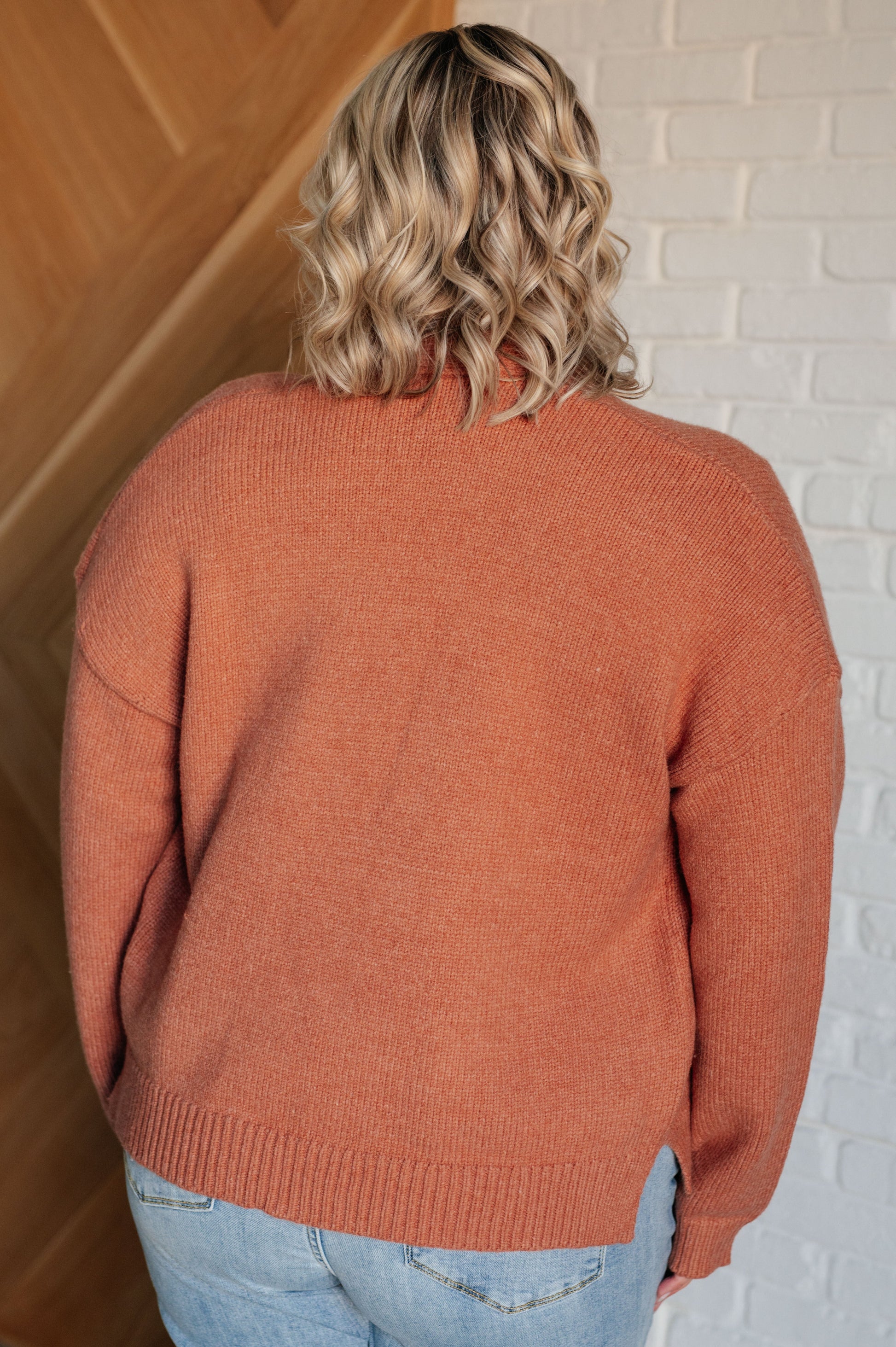 A women's cardigan made from brushed midweight sweater knit in a warm cider color. Features an open front design, long sleeves with drop shoulders, and a banded ribbed hemline.