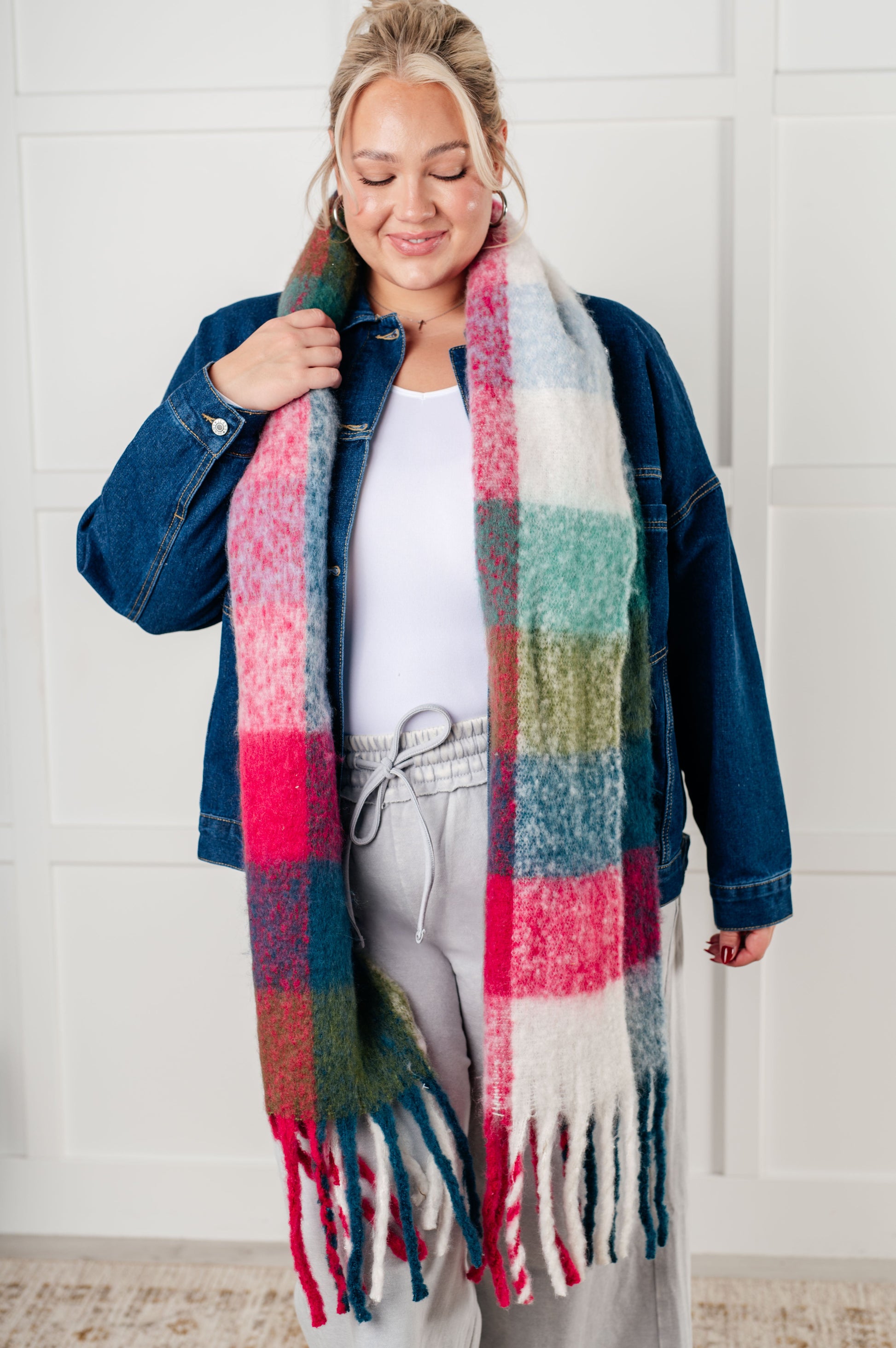 Women's oversized plaid fringe scarf in magenta and teal.