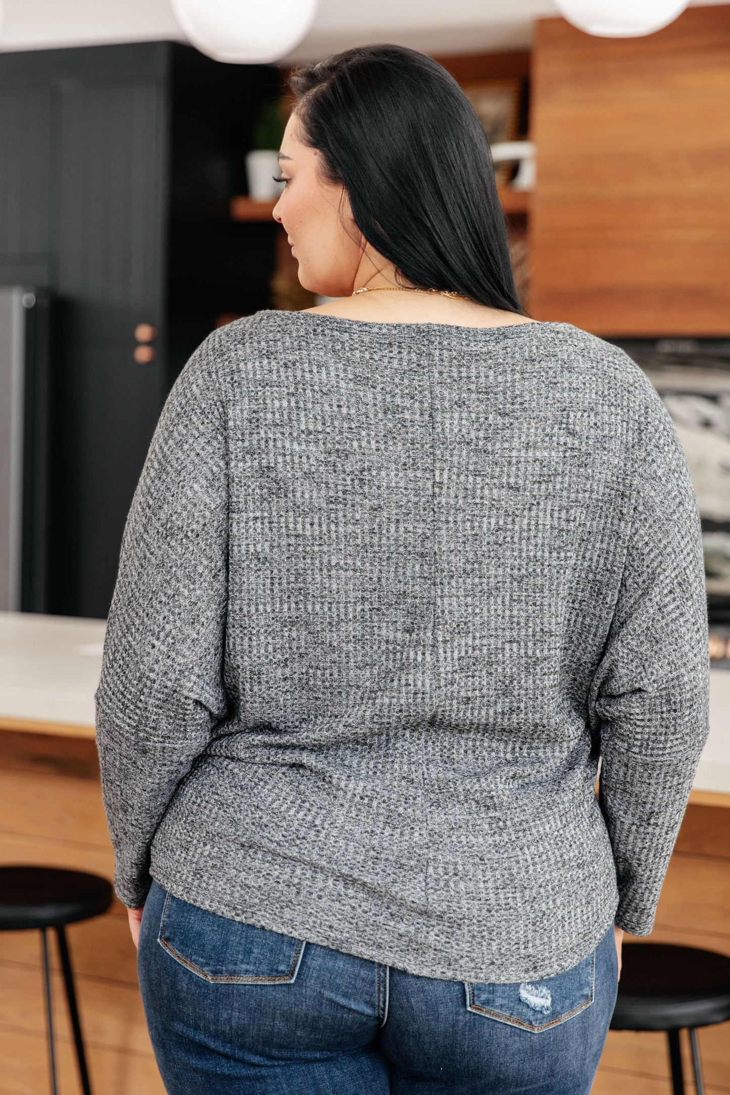 Charcoal waffle knit ribbed top with a wide boat neckline, long dolman sleeves, and a relaxed fit.