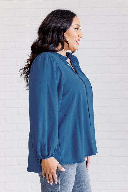 Plus size side view of Vesper Keyhole Tie Blouse showing self-tie keyhole neckline and textured fabric.