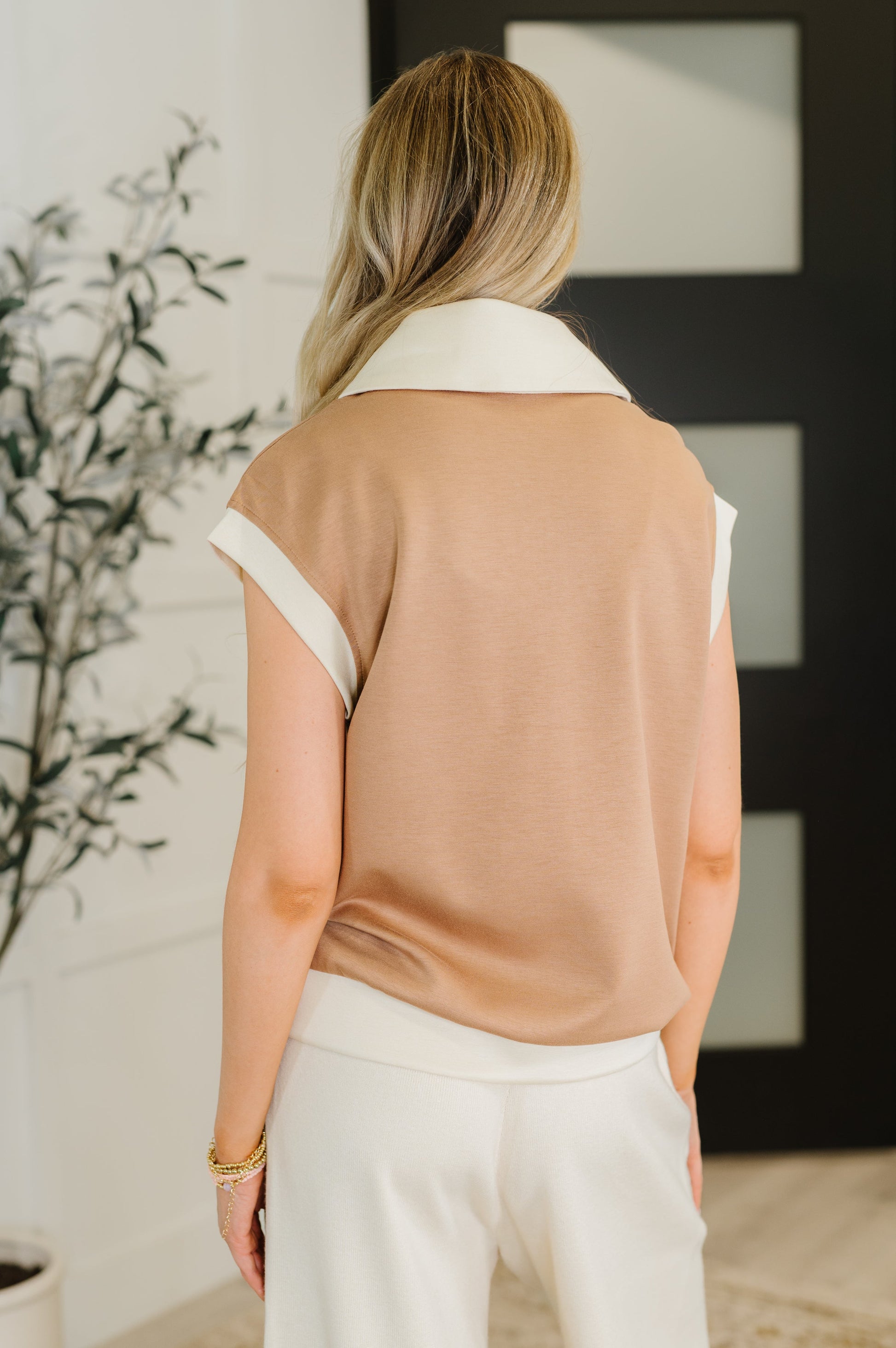 Back view of Jovie Color Block Half Zip Top in camel and beige color block with banded hemline.