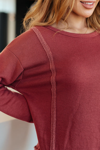 Close-up of Taya Pullover highlighting exposed seams and reverse fabric detail in lightweight French terry.