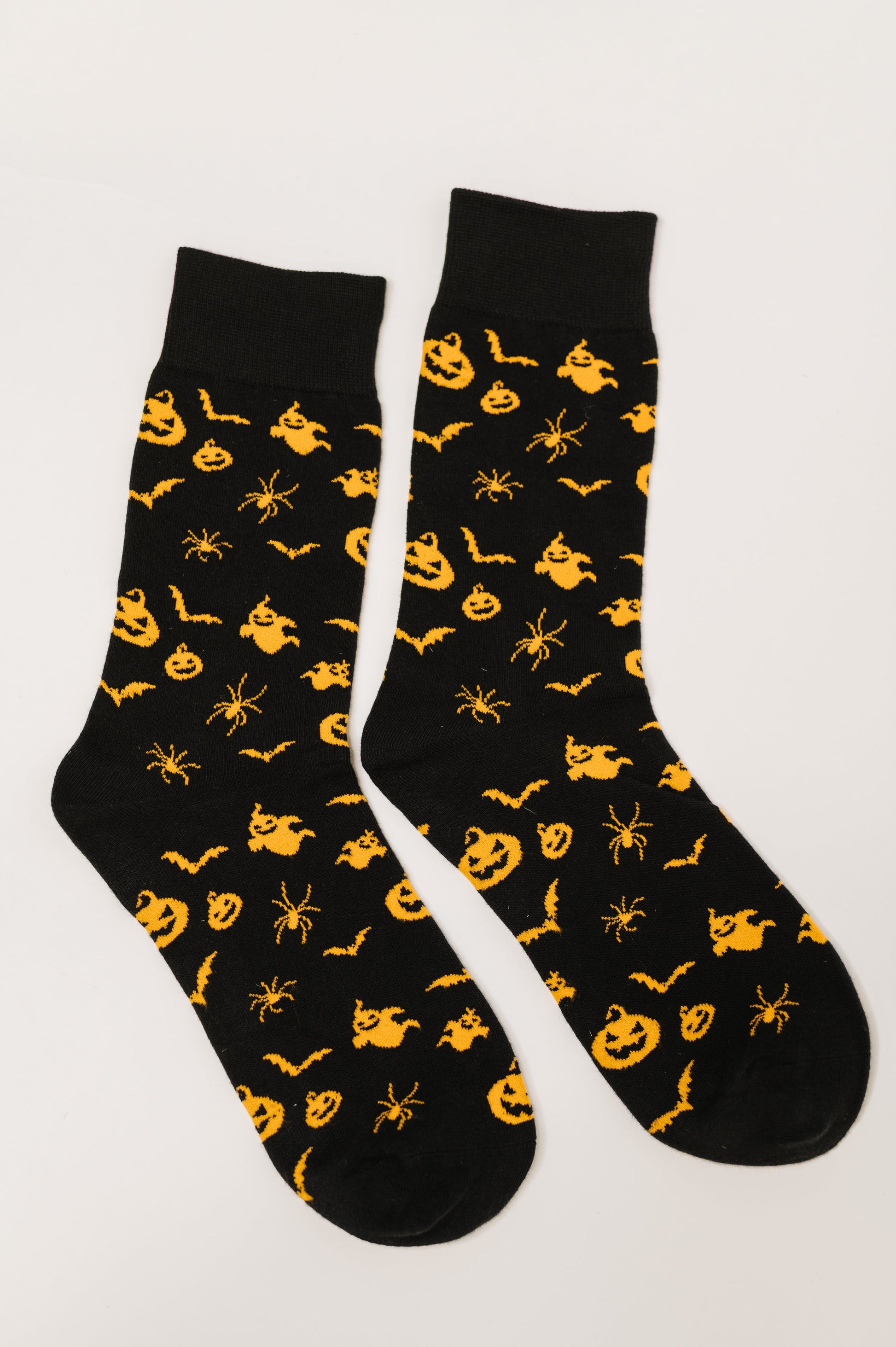 Flat lay of Wicked Walk Quarter Socks with pumpkin, bat, ghost, and spider print
