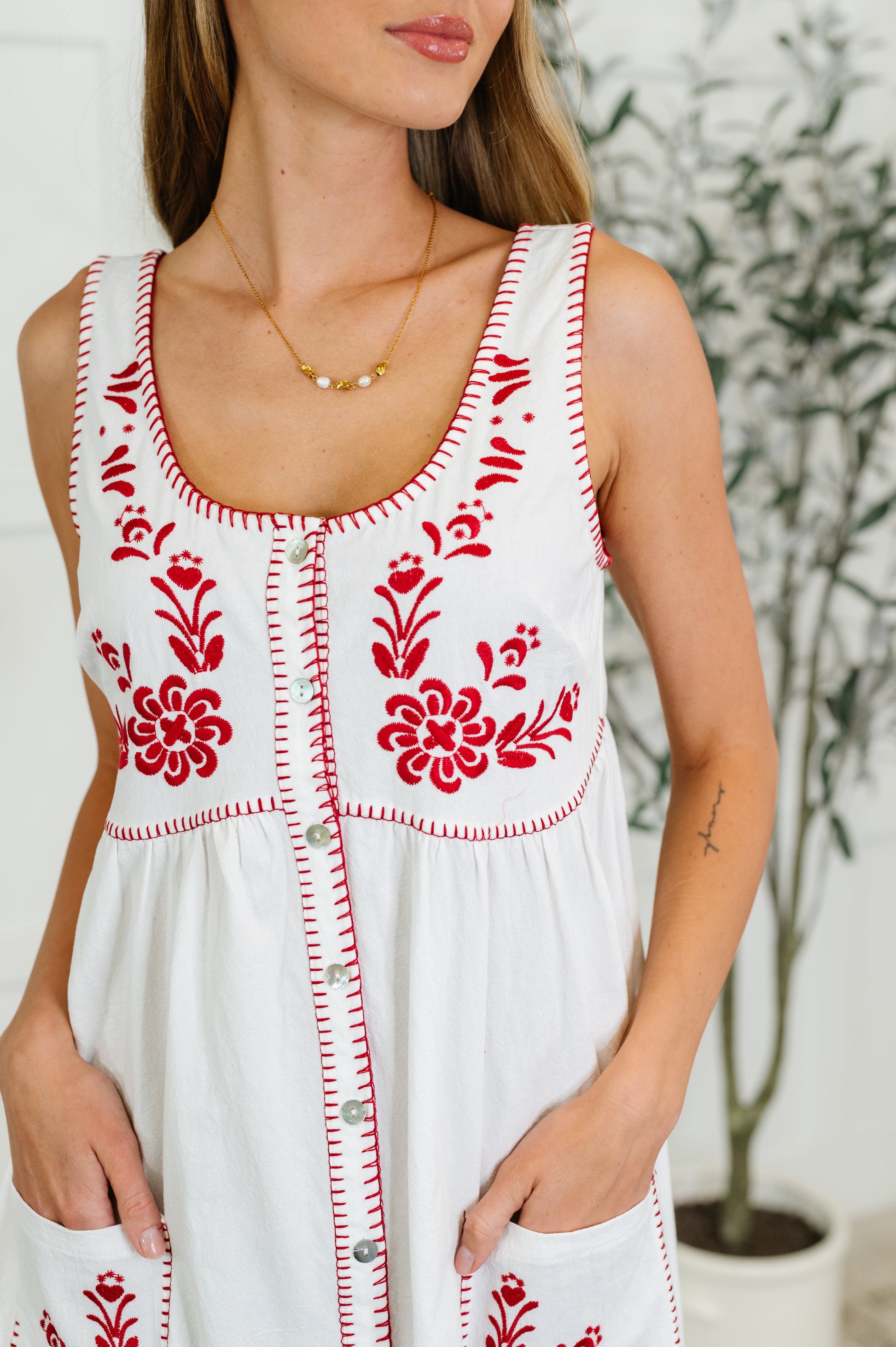 Close-up of blanket stitch hem and floral embroidery on the Wiley Petals dress – breezy cotton blend sundress for women.