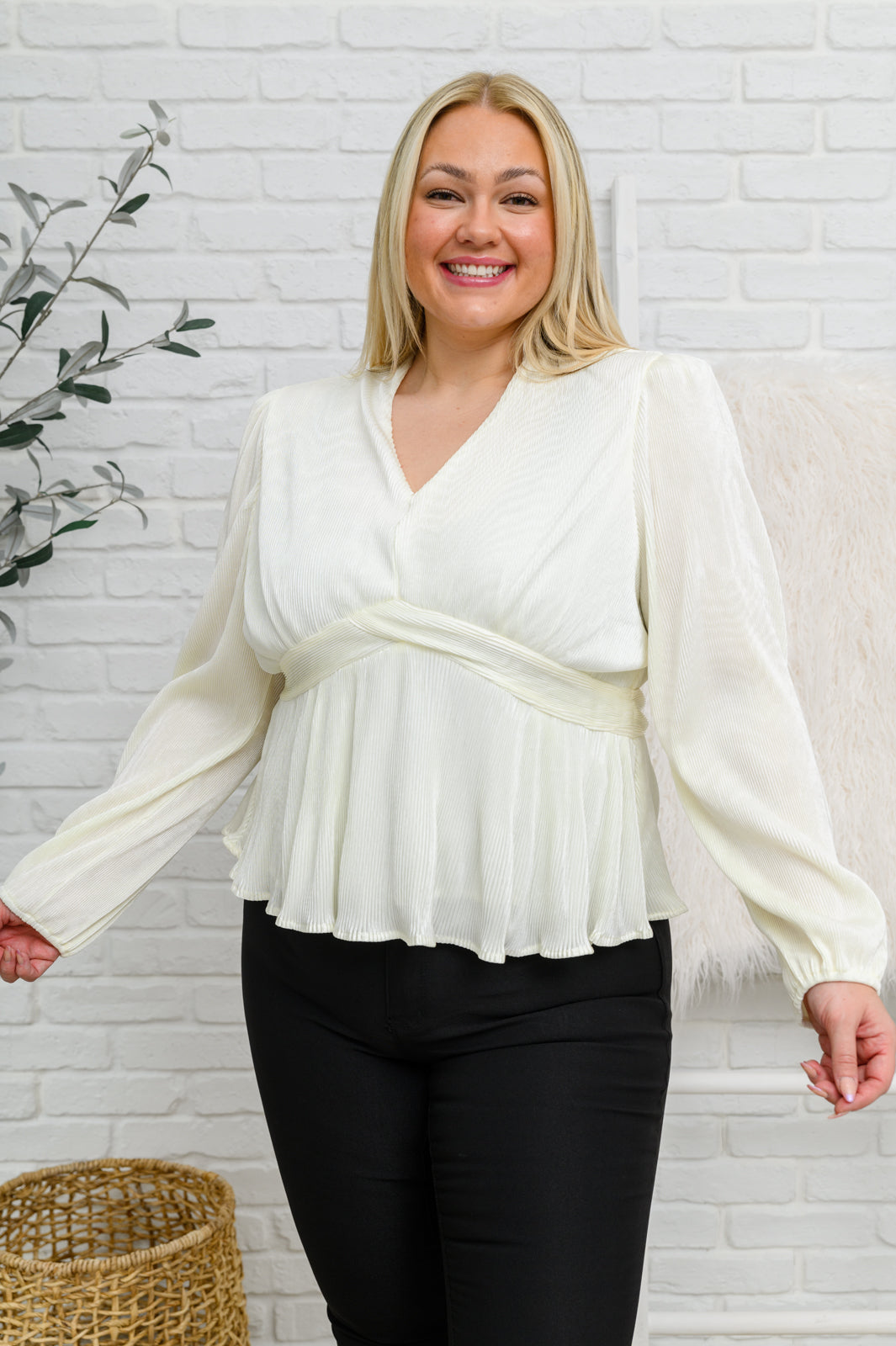 Women's Long Sleeve V Neck Blouse in White with plissé fabric, V-neckline, peplum waist, balloon sleeves, and back zipper closure. Perfect for formal or casual occasions.