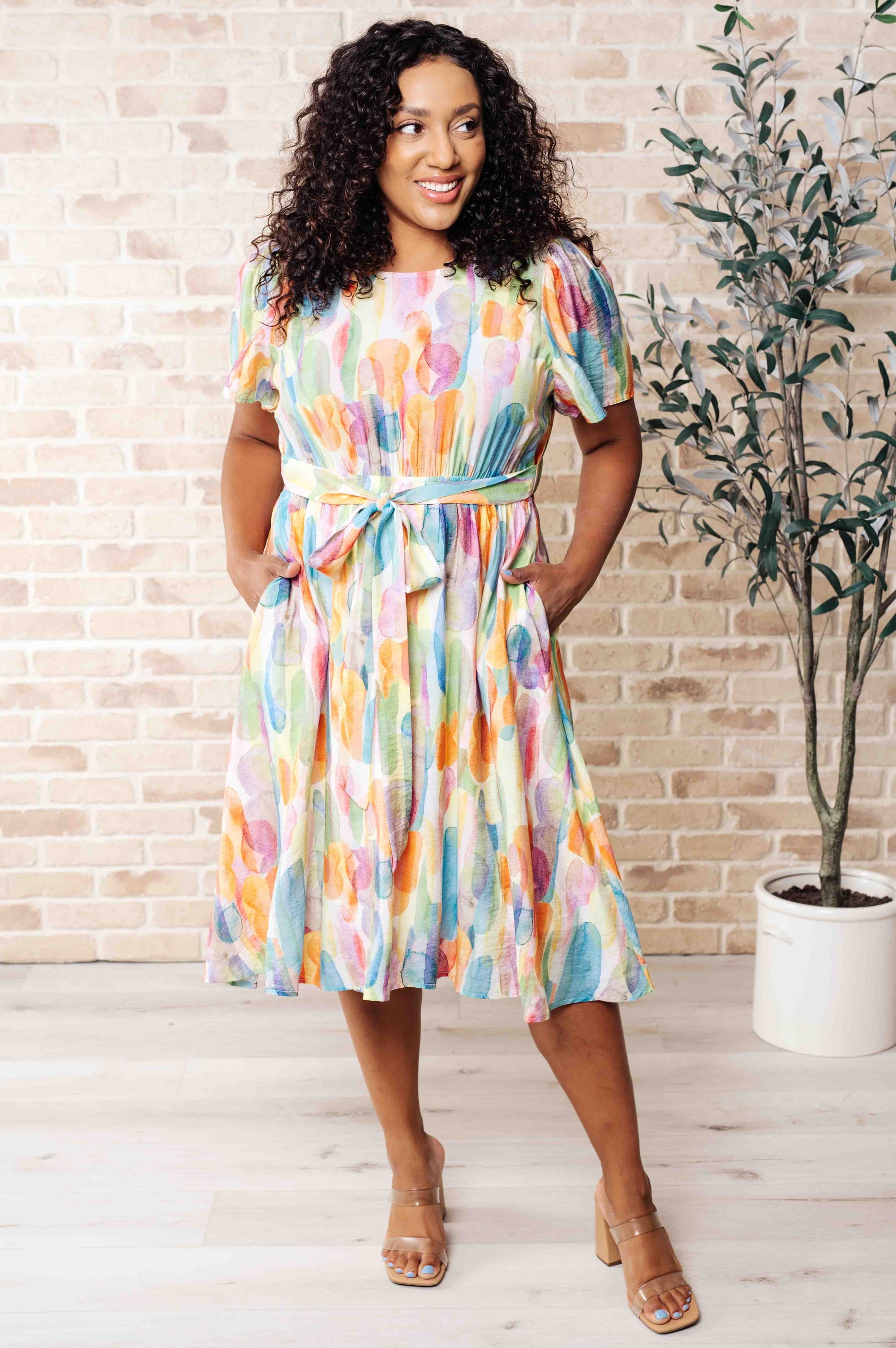 Yuna Round Neck Dress with watercolor print, short gathered sleeves, elastic waistline, and a keyhole back closure for a flattering and fun look.