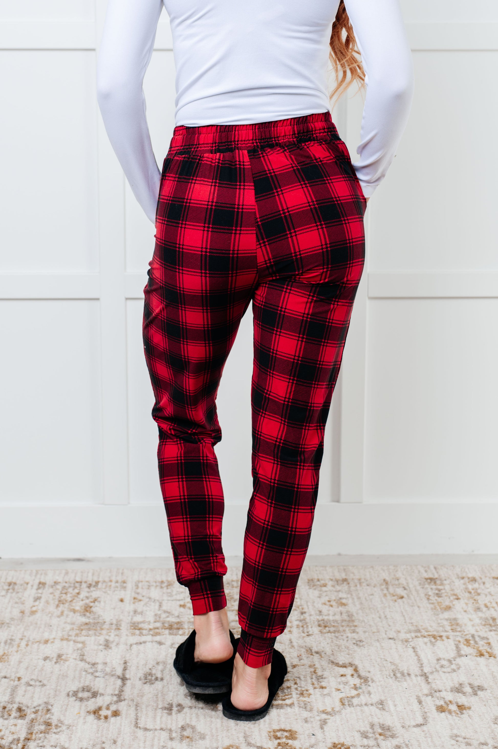 Women's joggers made from brushed microfiber in red plaid, featuring an elastic waistband, functional drawstring, and pockets.