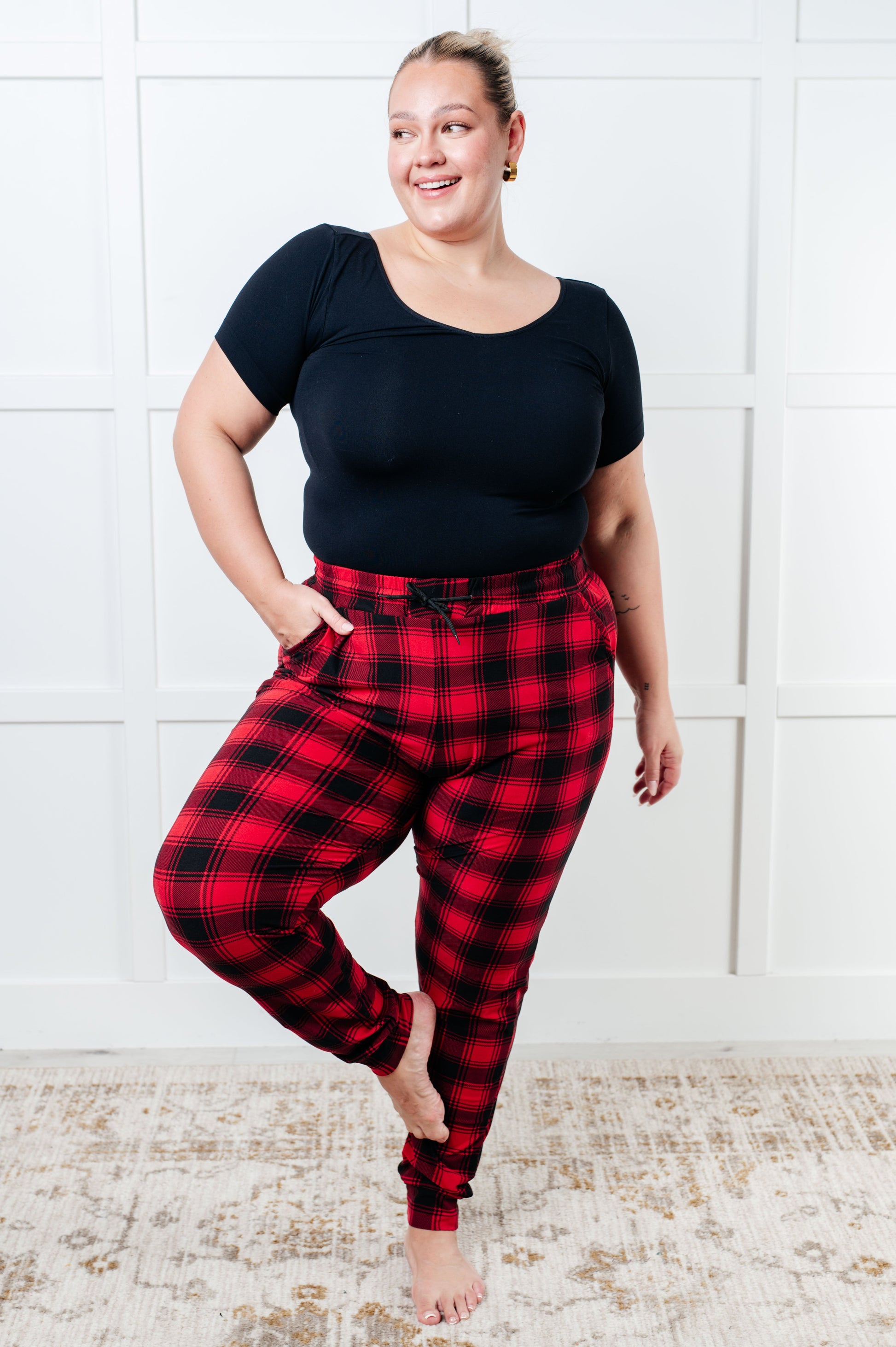 Women's joggers made from brushed microfiber in red plaid, featuring an elastic waistband, functional drawstring, and pockets.