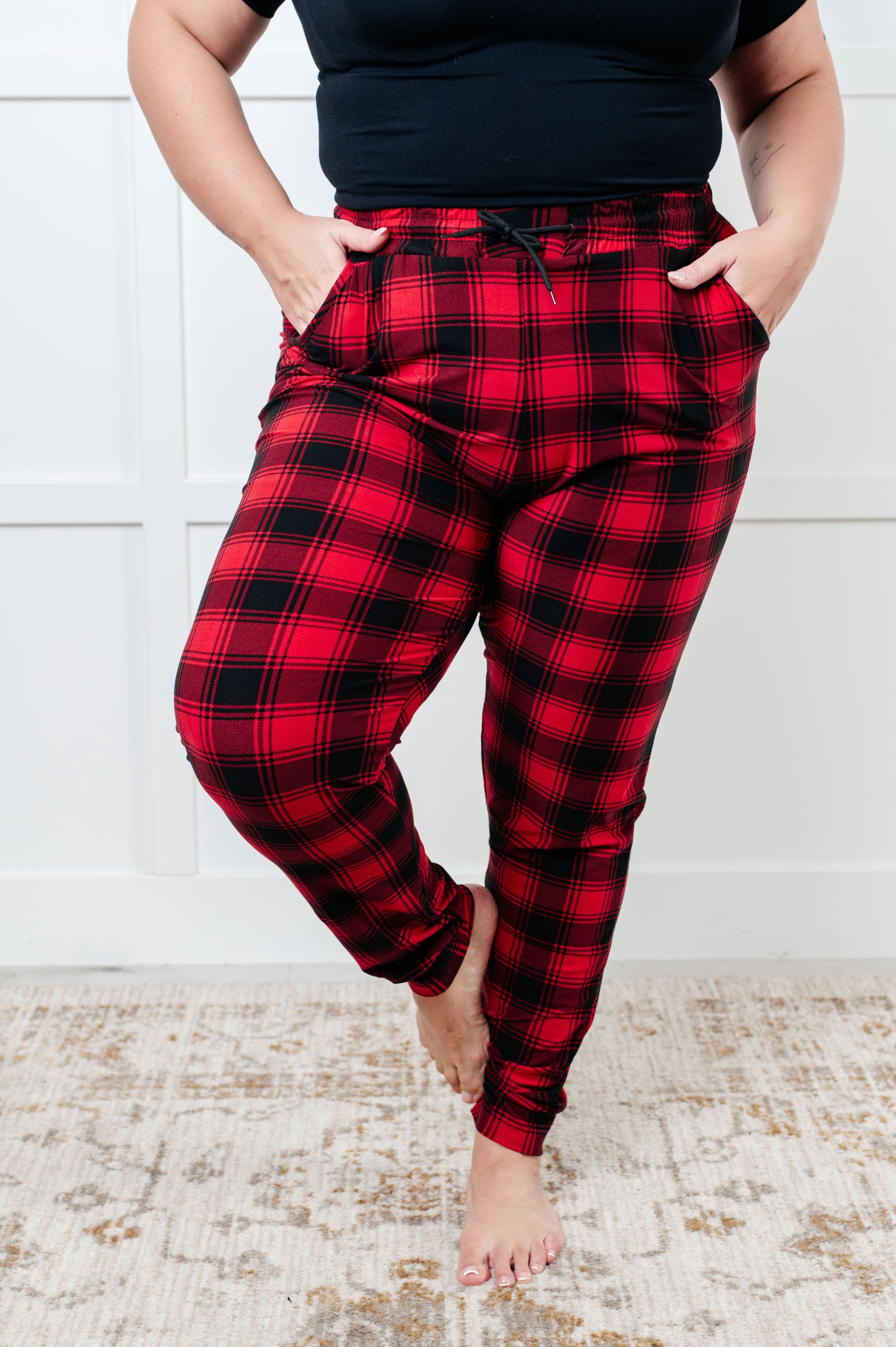 Women's joggers made from brushed microfiber in red plaid, featuring an elastic waistband, functional drawstring, and pockets.