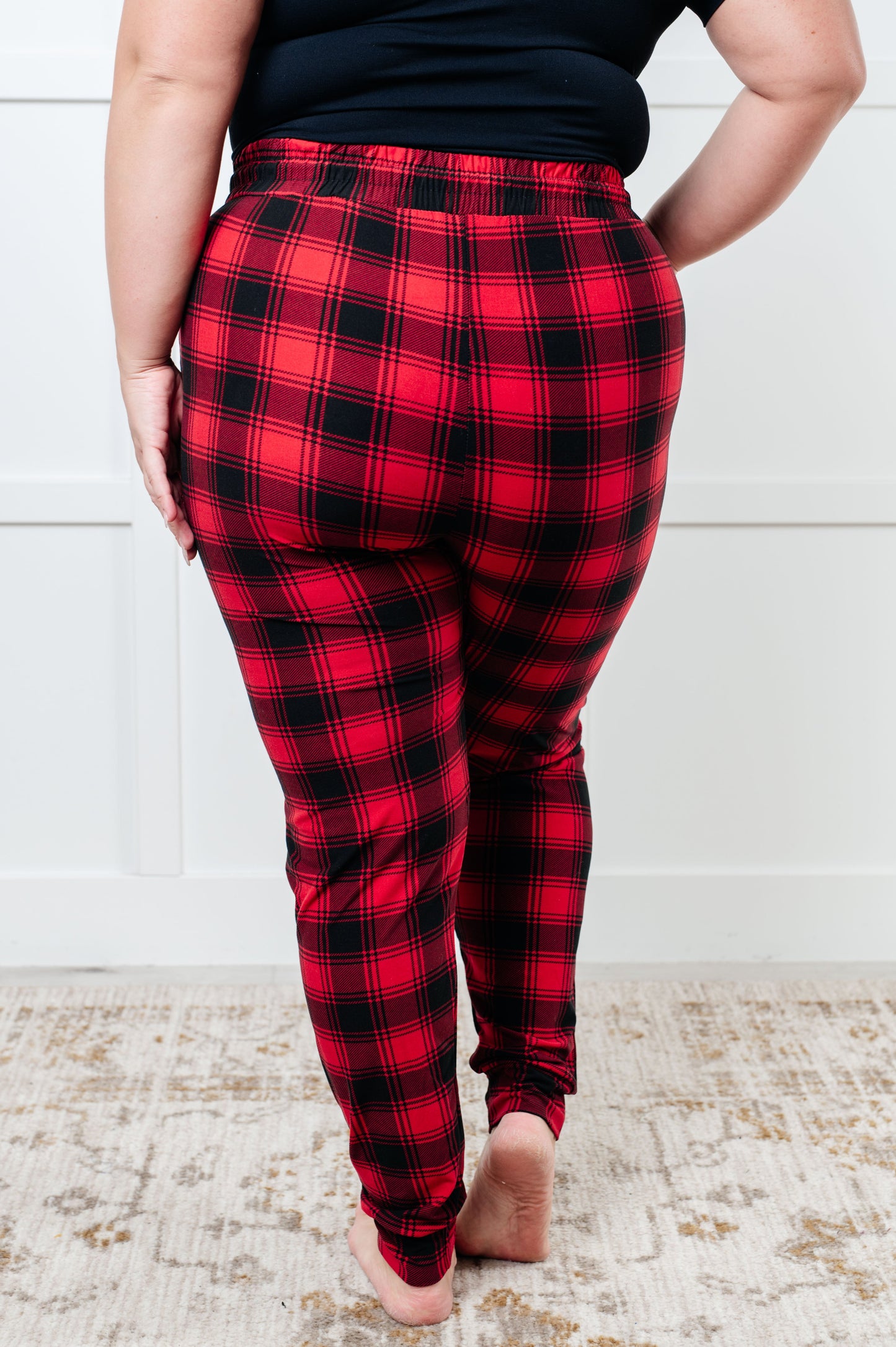 Women's joggers made from brushed microfiber in red plaid, featuring an elastic waistband, functional drawstring, and pockets.