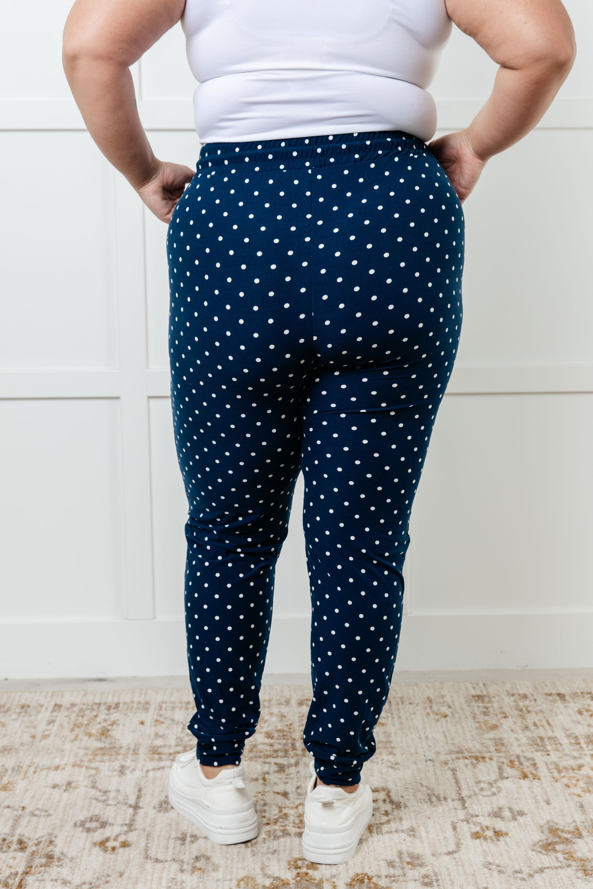 Women's joggers made from double-brushed microfiber in navy with a white polka-dot print, featuring an elastic waistband, functional drawstring, and pockets.