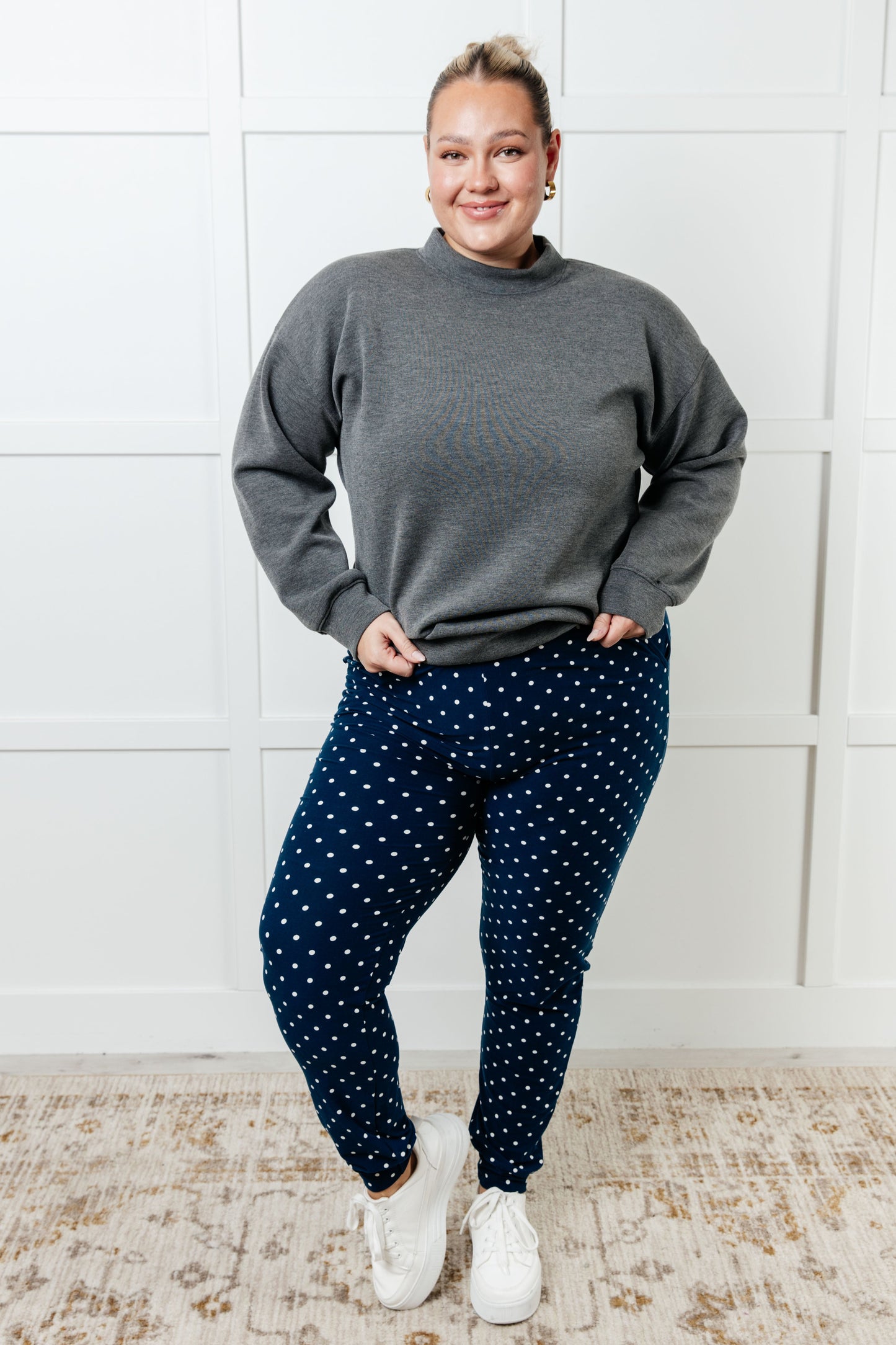 Women's joggers made from double-brushed microfiber in navy with a white polka-dot print, featuring an elastic waistband, functional drawstring, and pockets.