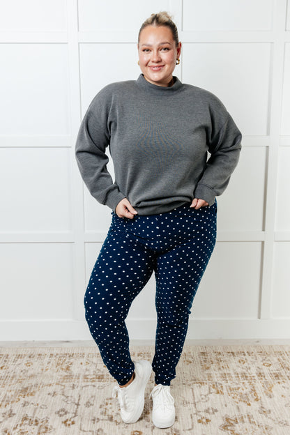Plus size model in Merrick White Polka Dot Joggers, full body view showing relaxed fit and playful style.