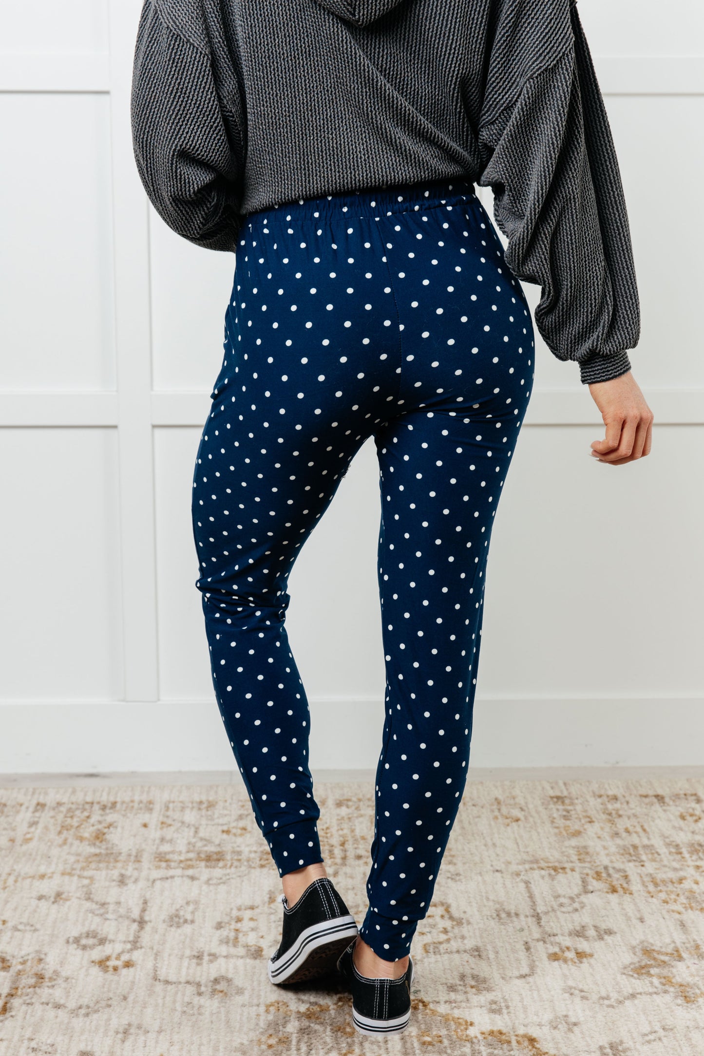 Women's joggers made from double-brushed microfiber in navy with a white polka-dot print, featuring an elastic waistband, functional drawstring, and pockets.