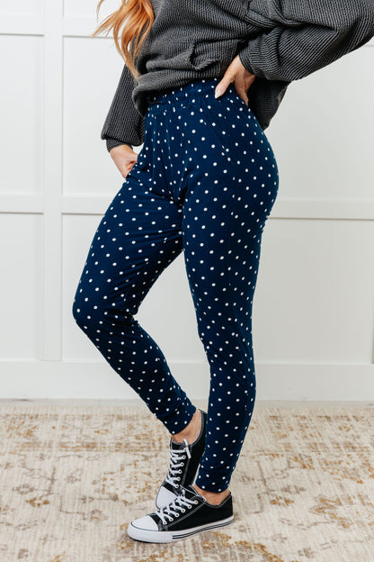Side view of Merrick White Polka Dot Joggers on standard model, showing tapered silhouette and pockets.