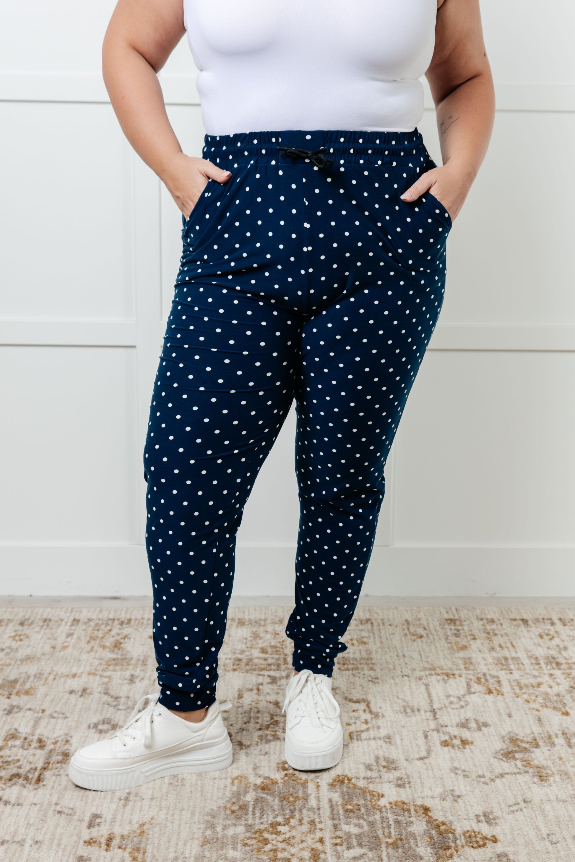 Women's joggers made from double-brushed microfiber in navy with a white polka-dot print, featuring an elastic waistband, functional drawstring, and pockets.