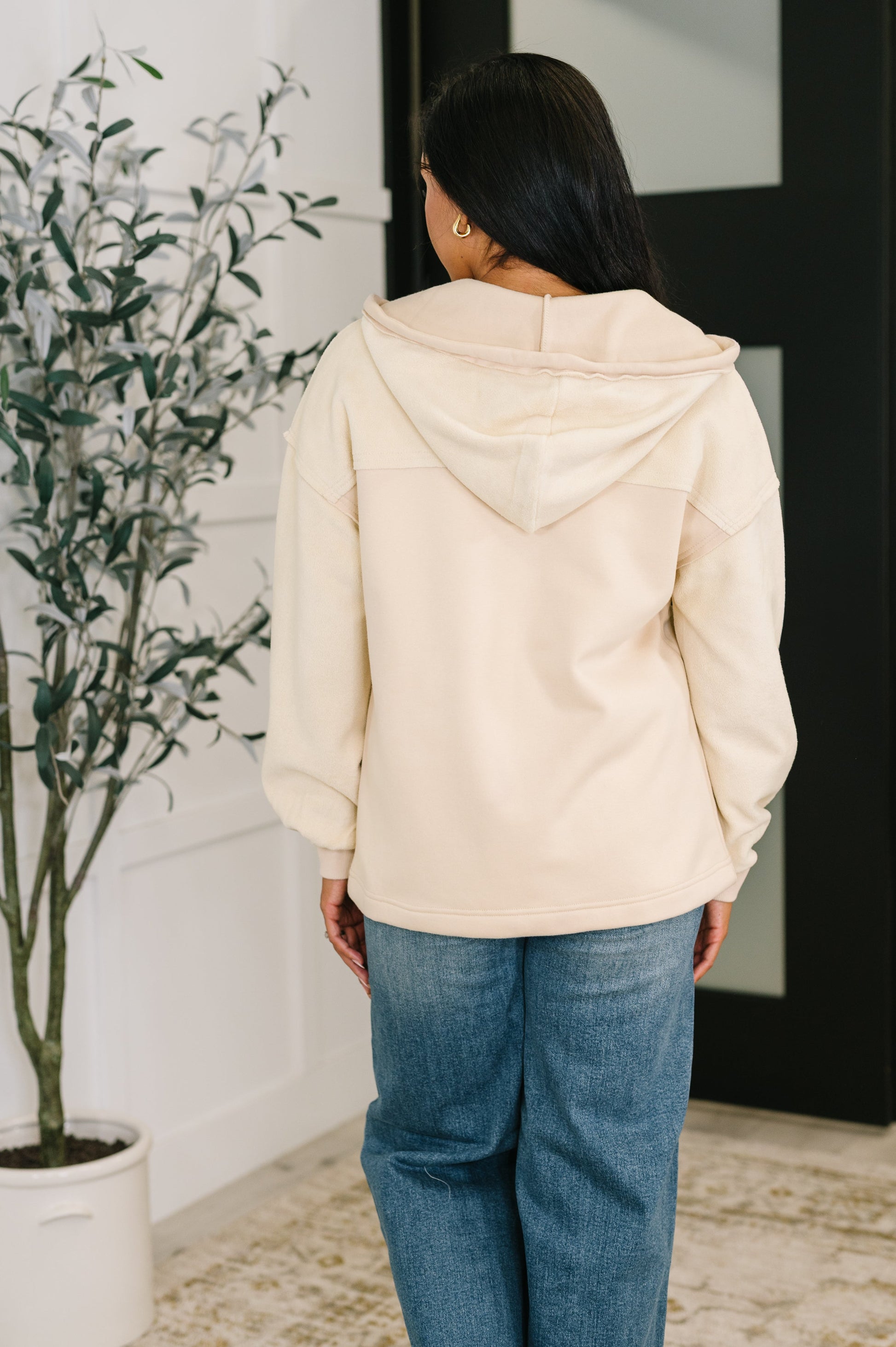 Back of Leona Zip-Up Hoodie in cream fleece with hood and seam details.