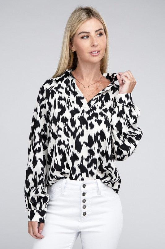 Black and white animal print collared shirt with long sleeves and a relaxed drop-shoulder design.