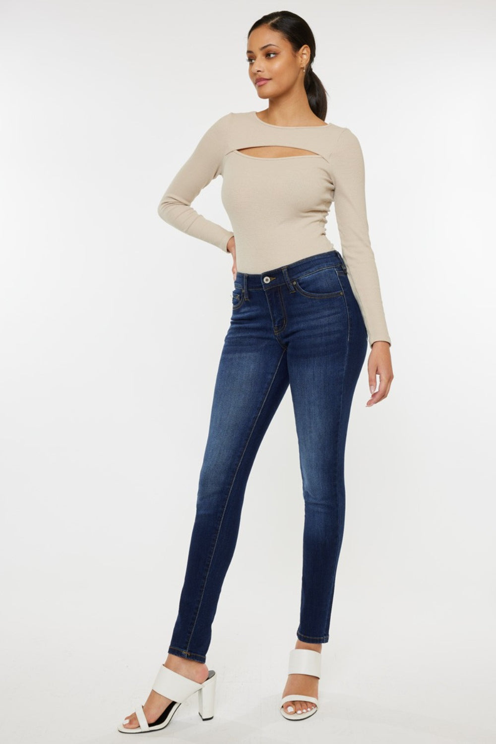 Mid rise gradient skinny jeans with a dark wash. Slightly stretchy, with pockets and a zip fly closure.