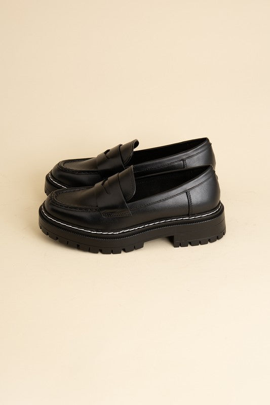 Black classic loafers with a sleek design and minimalist accents.